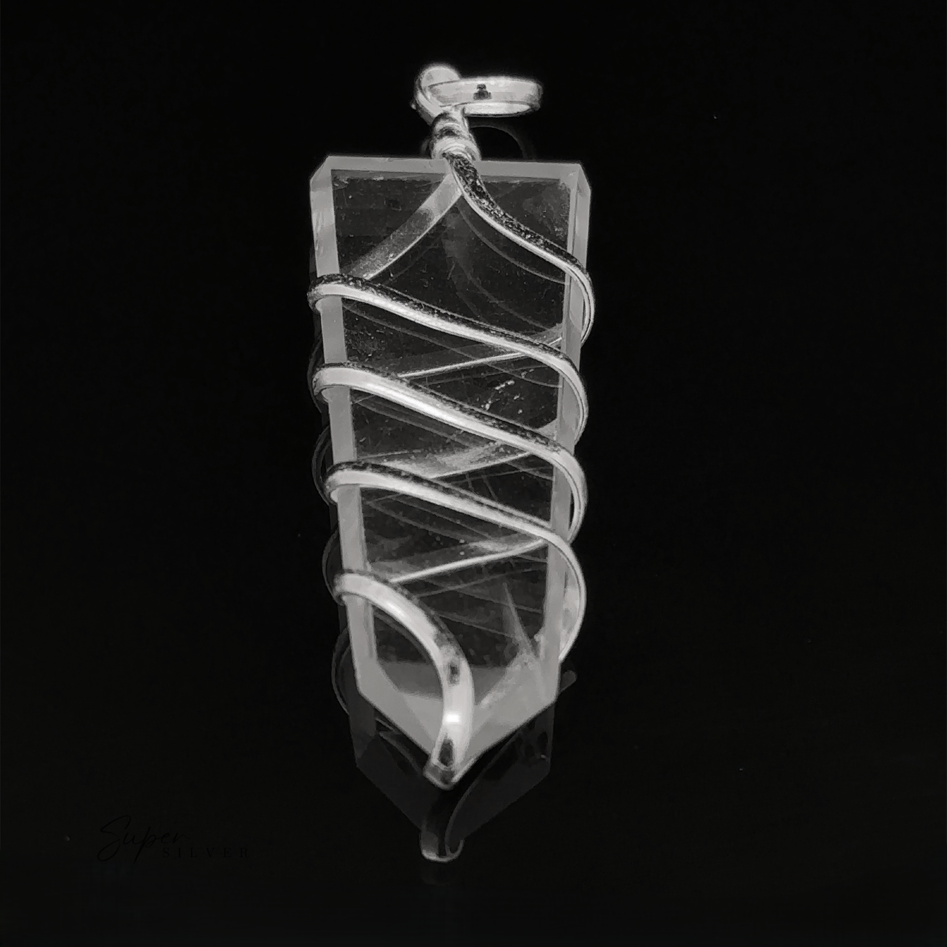 A Wire Wrapped Slab Pendant hanging against a dark background.