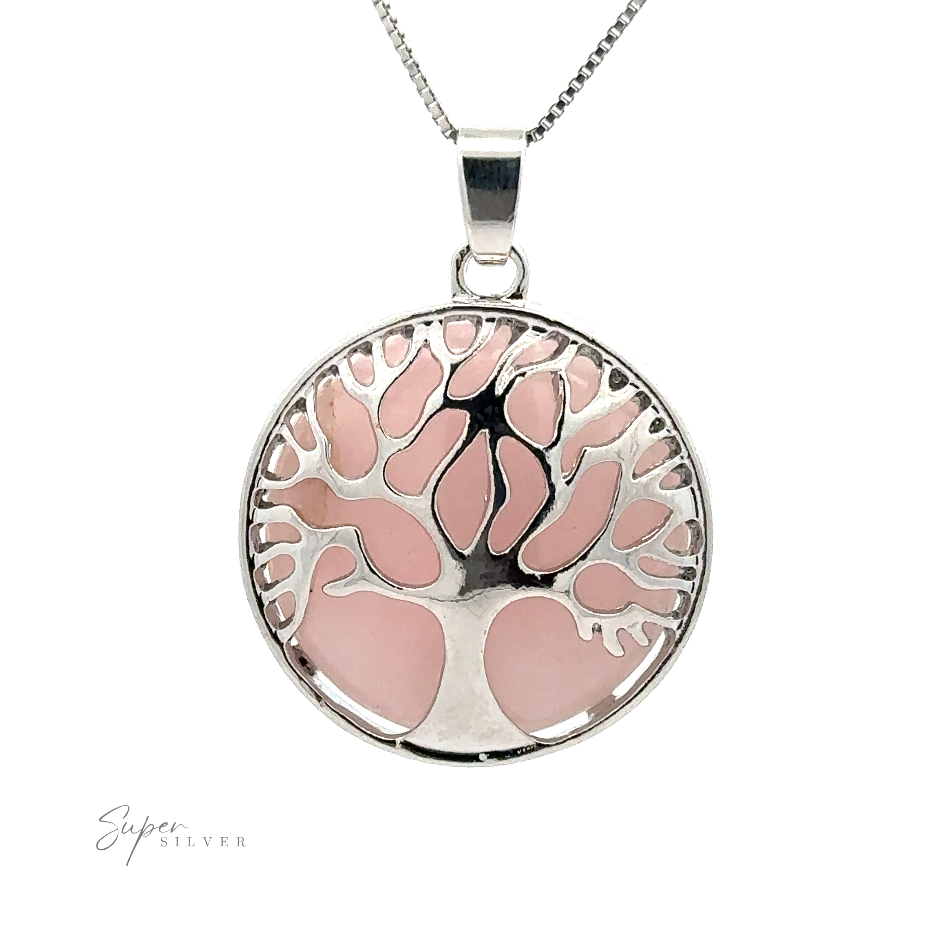 A Tree of Life Pendant with a circular Tree of Life pendant against a pink background. The pendant hangs from a thin chain, and the text "Super Silver" is visible in the bottom left corner.