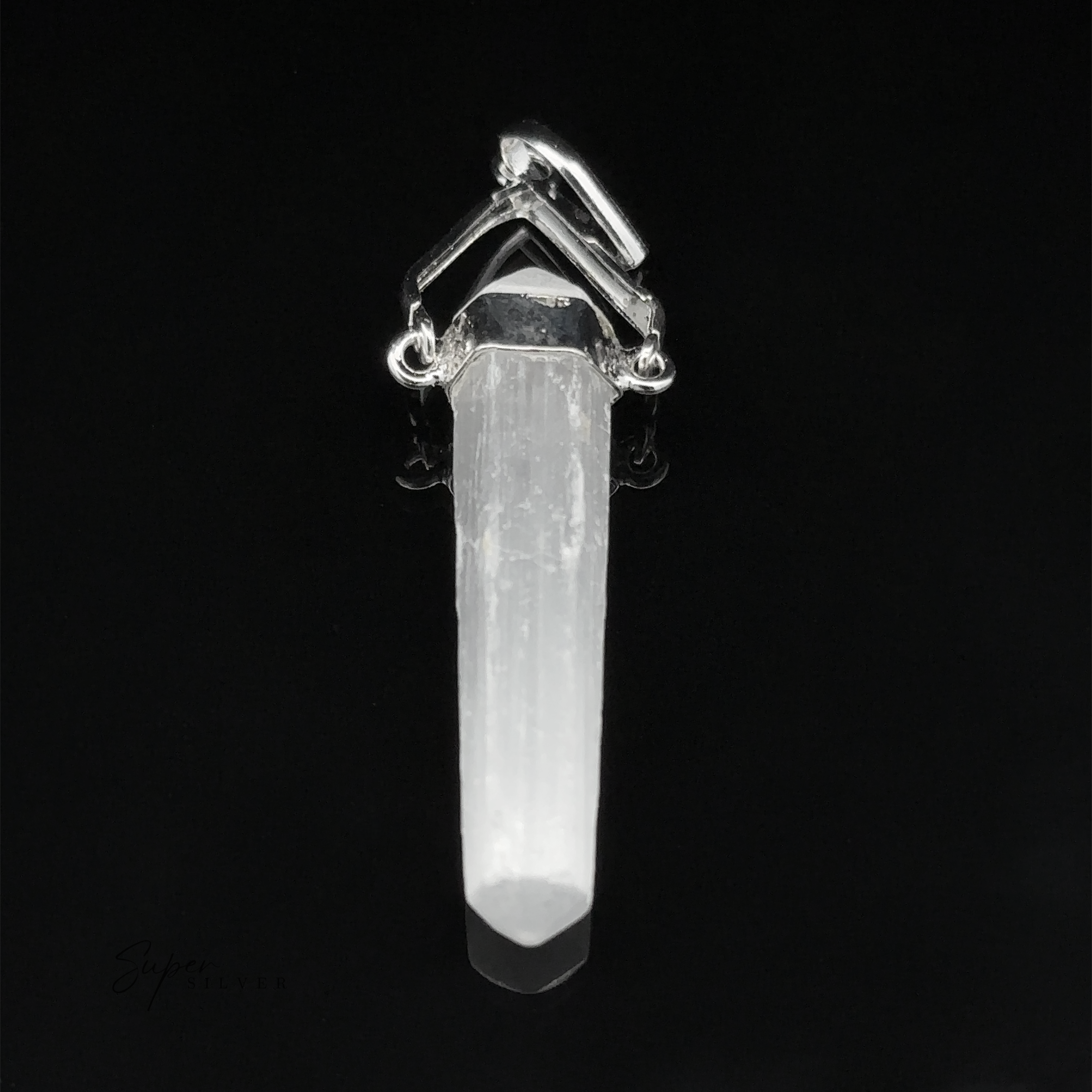A Raw Stone Swivel Pendant with silver accents sits elegantly in its silver-plated setting, featuring a pointed end against a black background.