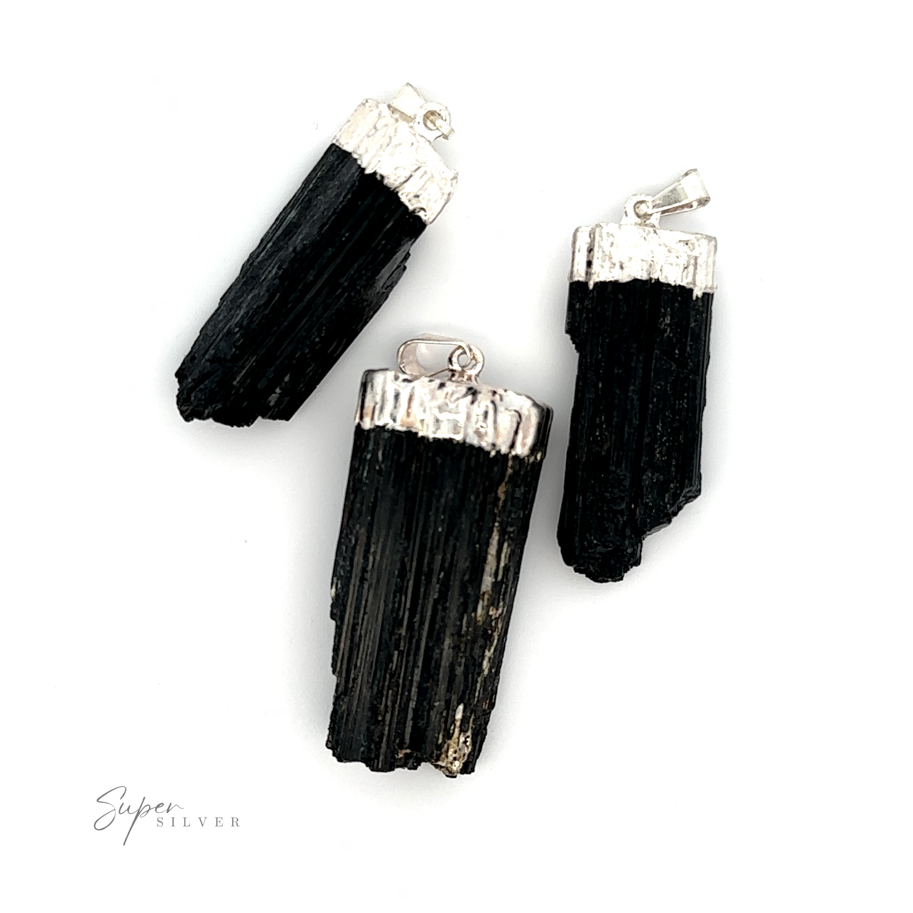 Three Raw Crystal Pendants With Silver Caps and bails are displayed on a white background.