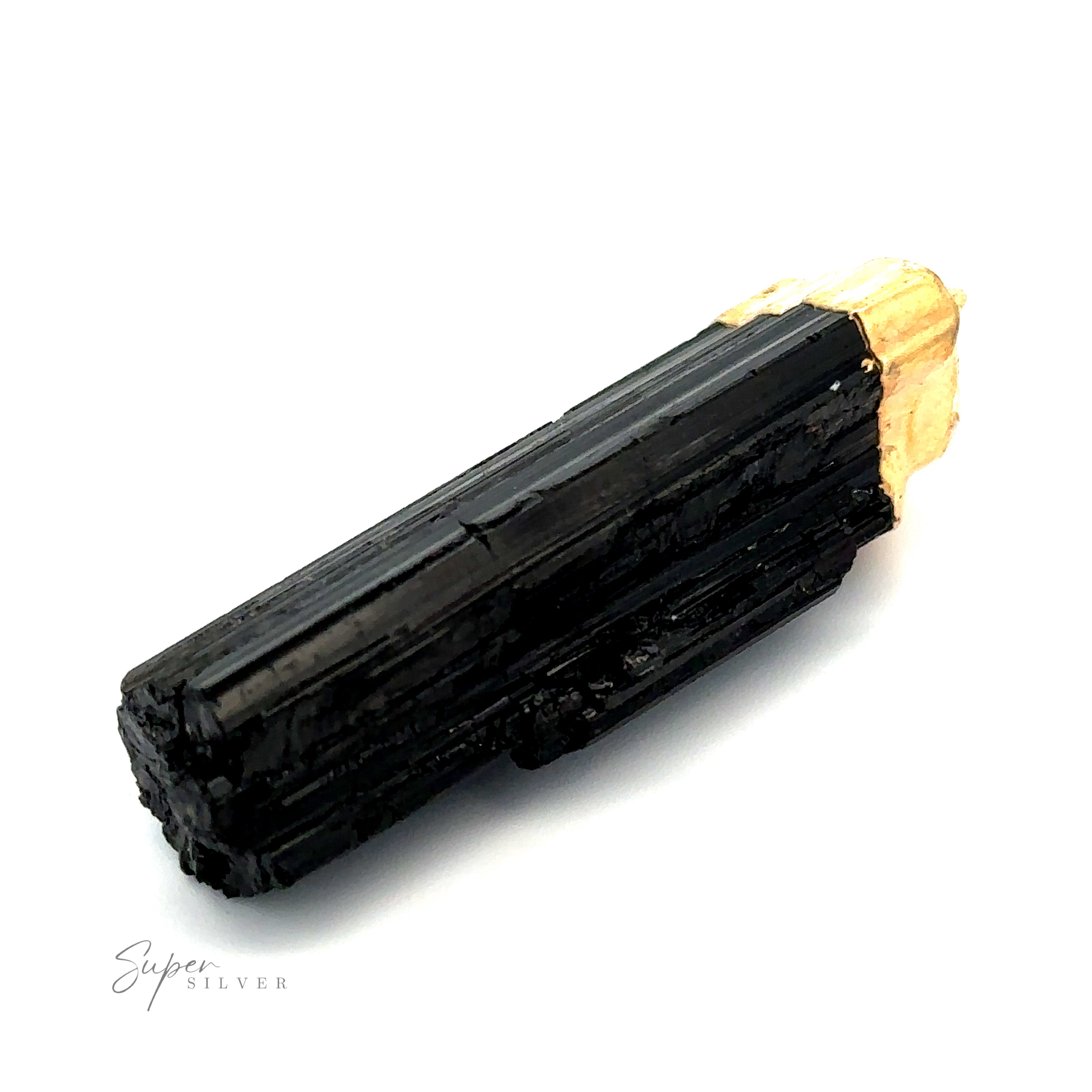 A long, black tourmaline crystal with a rough, natural texture and a small section of yellowish mineral at one end, resembling an exquisite Raw Crystal Pendant With Gold Cap, isolated on a white background.