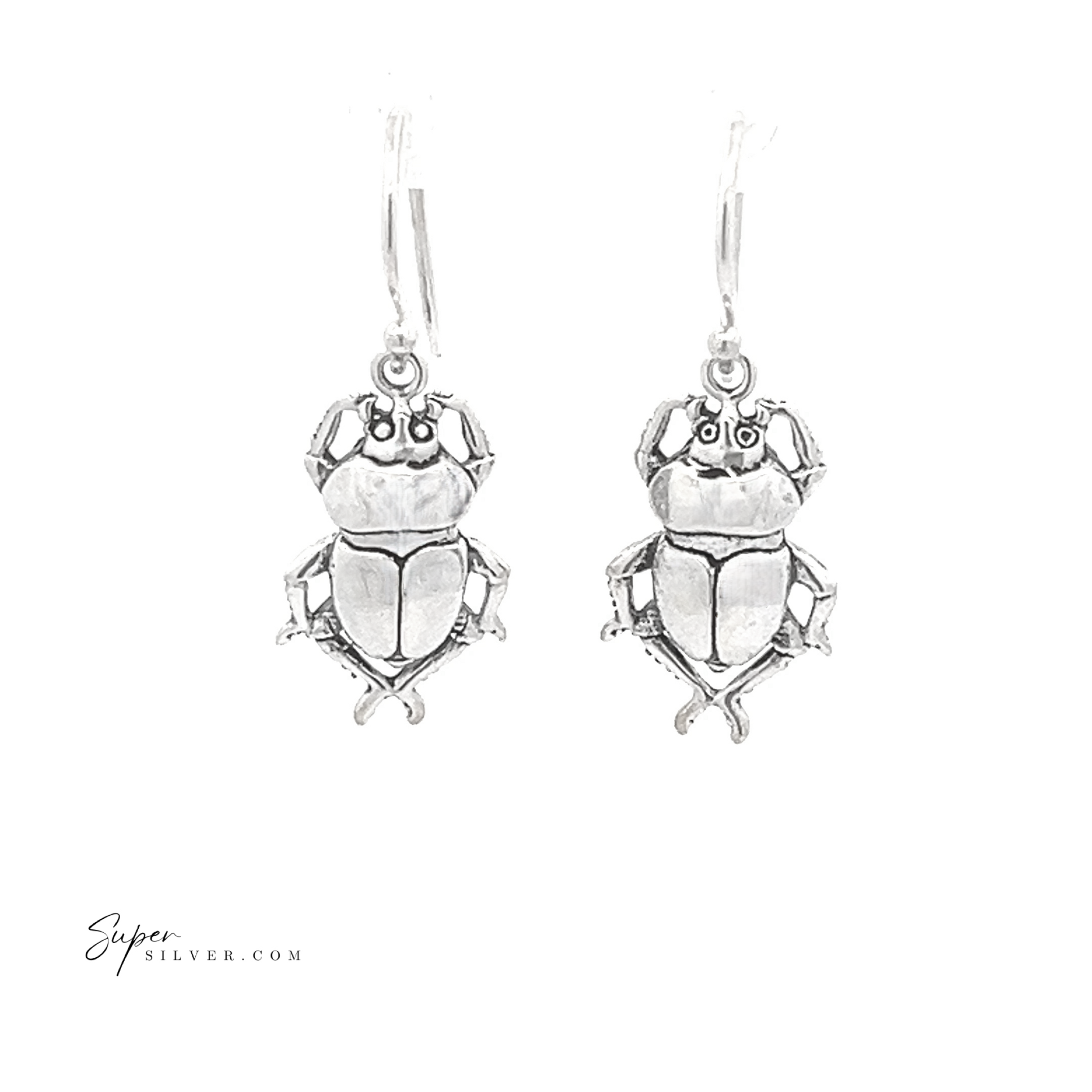 Set against a white background, the Beetle Earrings are a pair of sterling silver scarab beetles featuring detailed engravings that evoke the allure of ancient Egyptian jewelry.
