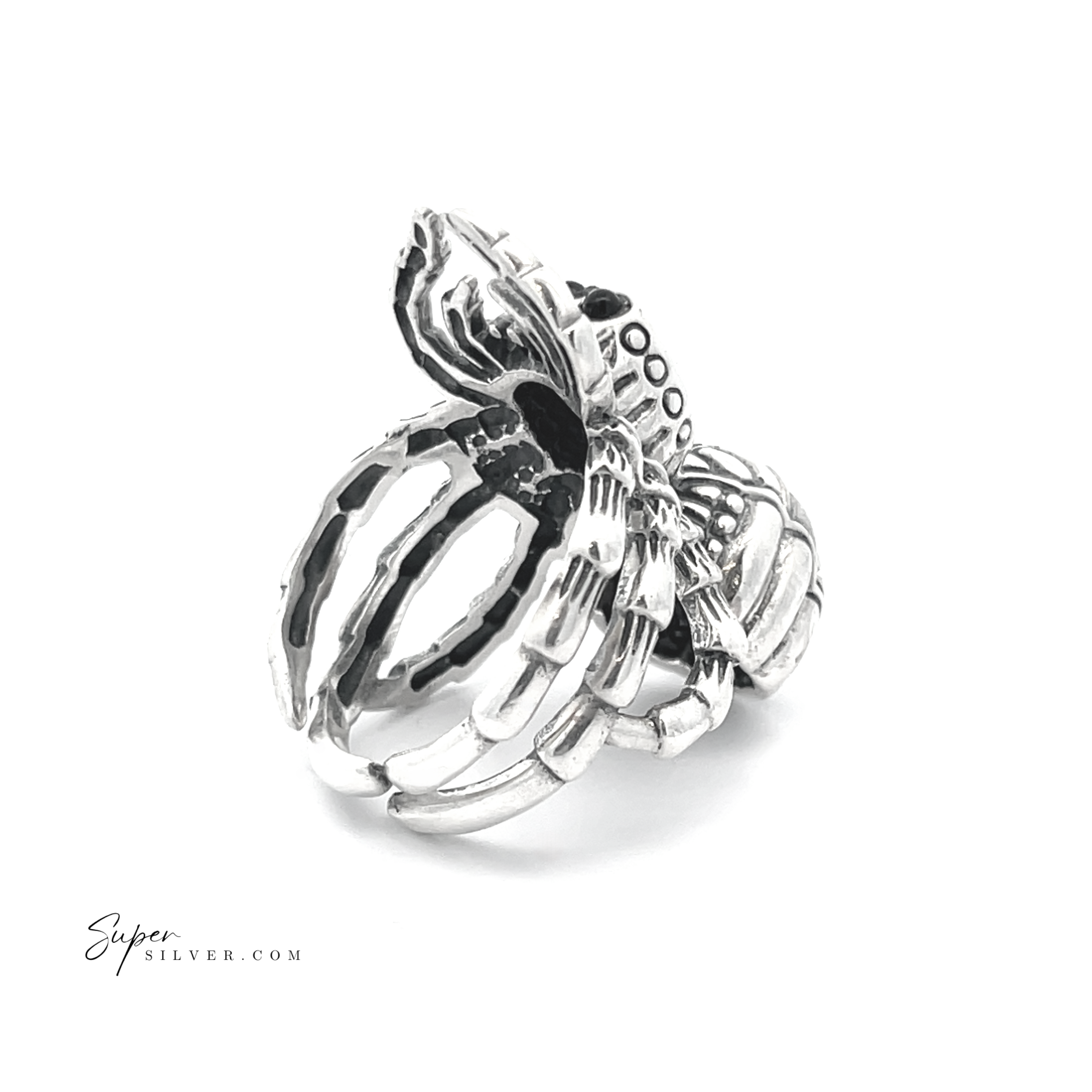 This adjustable statement spider ring, crafted from sterling silver and featuring intricate detailing on a white background, epitomizes unique and artistic handcrafted jewelry.