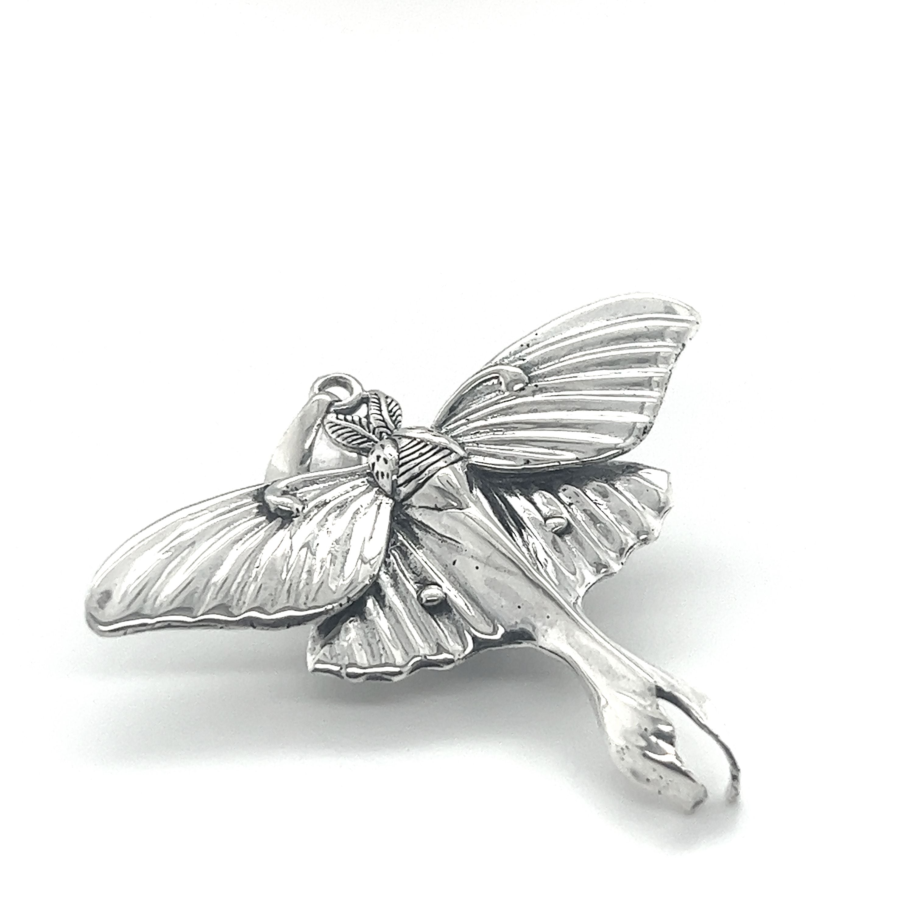 An ethereal Super Silver Statement Lunar Moth Pendant, symbolizing transformation, displayed against a serene white background.