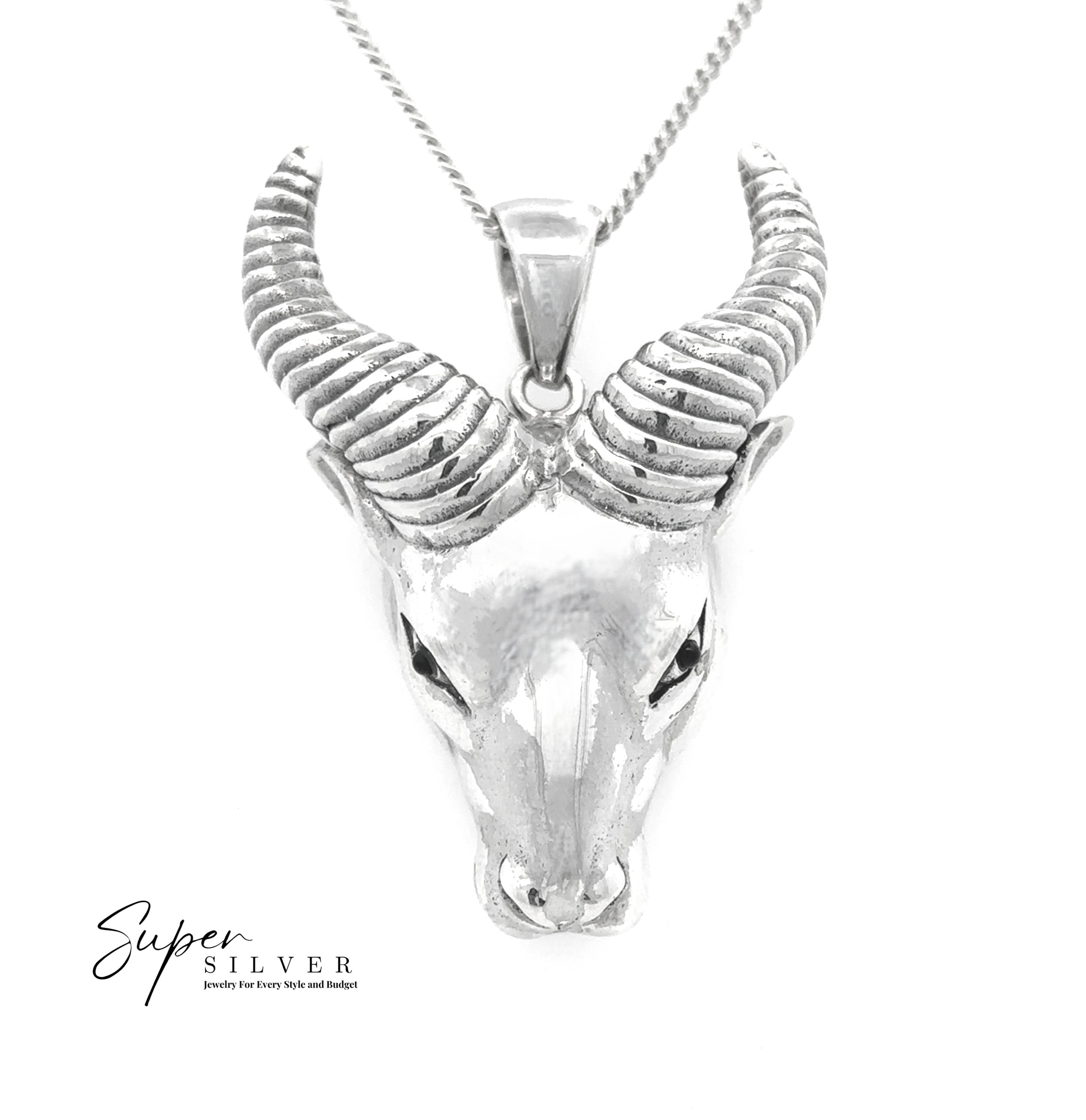 The Ram Statement Pendant showcases a silver ram head with curled horns on a chain, set against a white background. This bold piece of gothic jewelry features the "Super Silver" logo in the bottom left corner.