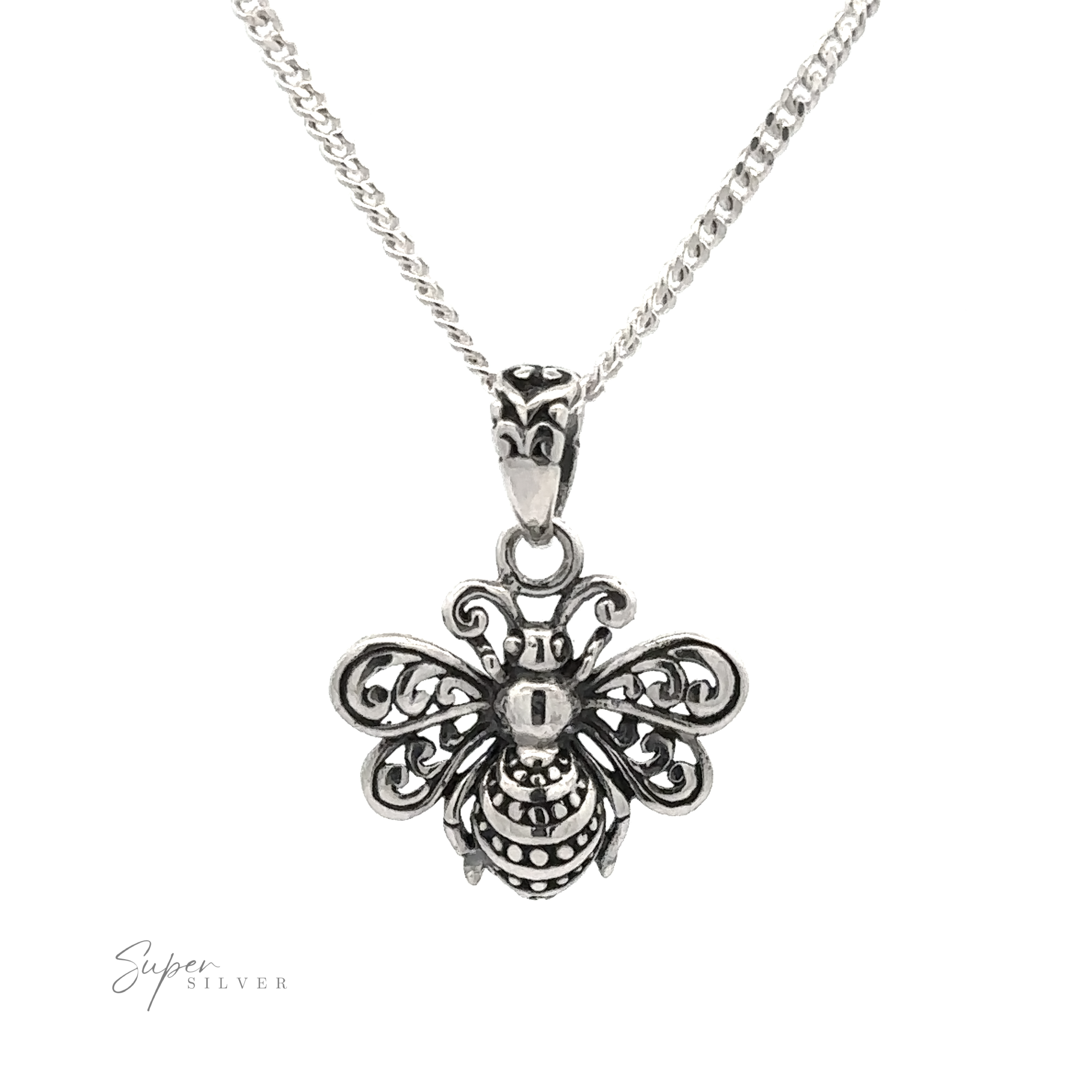 The Filigree Bee Pendant, crafted from .925 Sterling Silver, features intricate detailing and hangs elegantly on a fine chain necklace against a white background. This piece of artisan jewelry is both delicate and stunning.