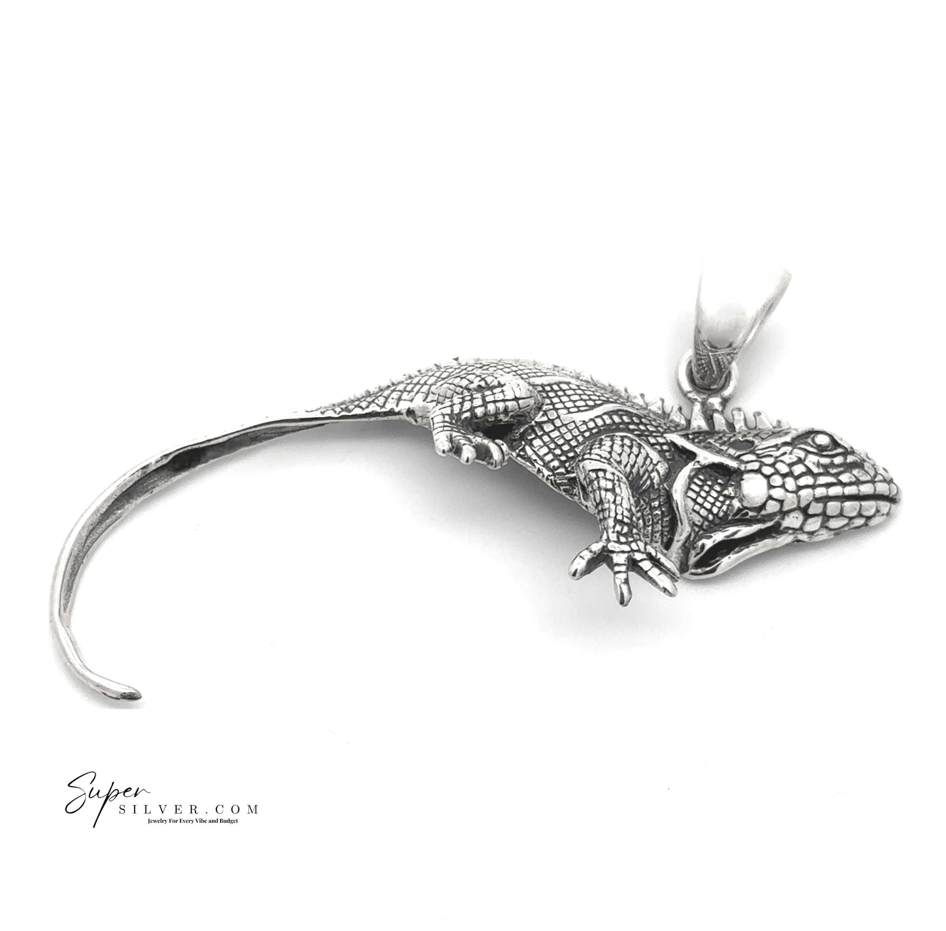 The Iguana Pendant features detailed sterling silver scales and a curled tail, shown on a white background. Part of the Artssina Collection, this elegant piece captures lifelike iguana charm in unique silver jewelry.