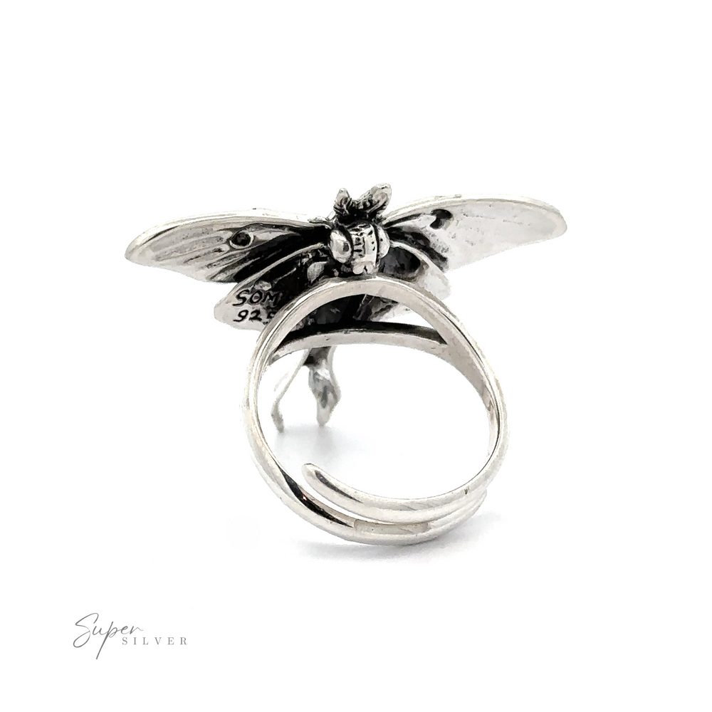 
                  
                    Statement Lunar Moth Ring with a detailed dragonfly design on the top, showing hallmarks on the wings, against a white background.
                  
                