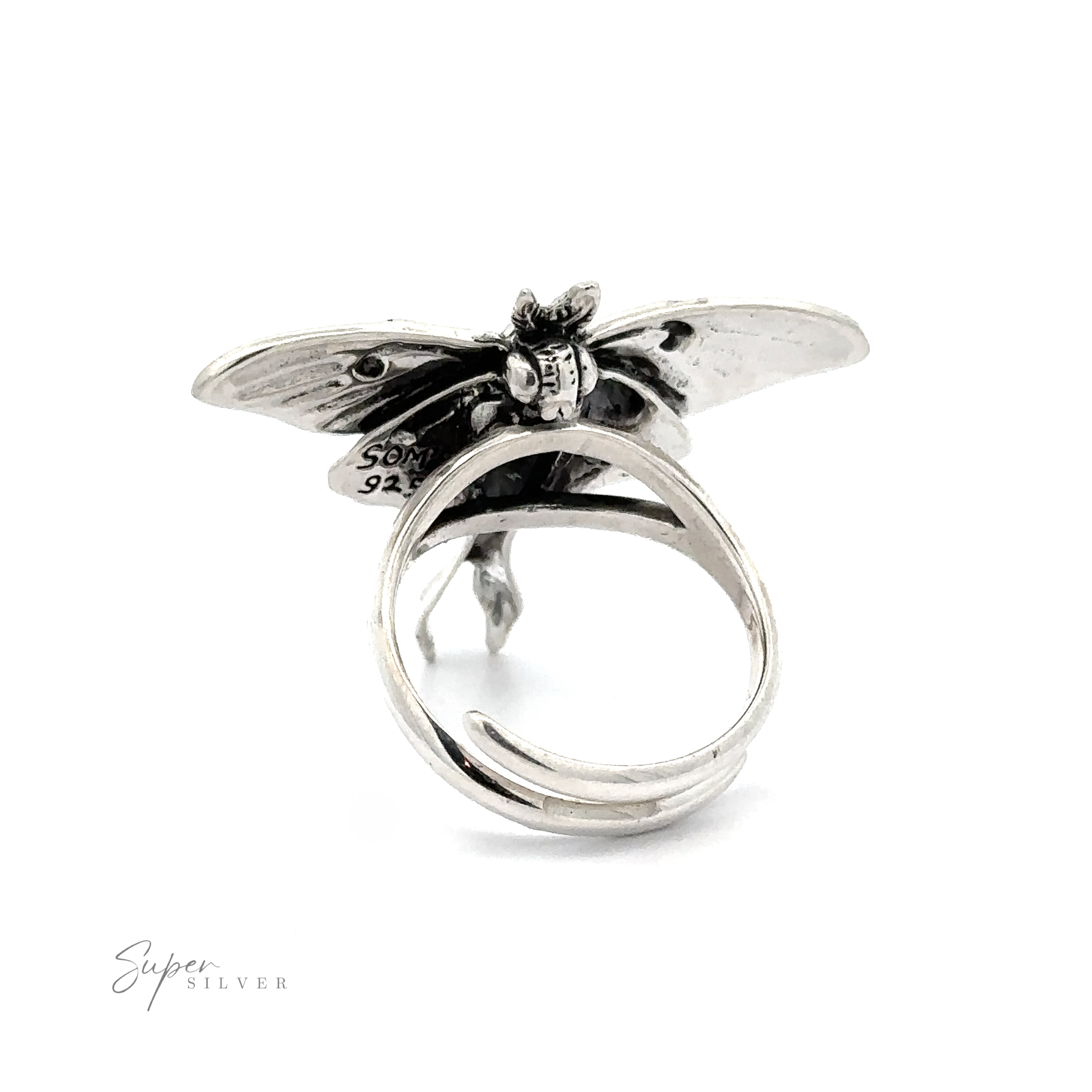 Statement Lunar Moth Ring with a detailed dragonfly design on the top, showing hallmarks on the wings, against a white background.