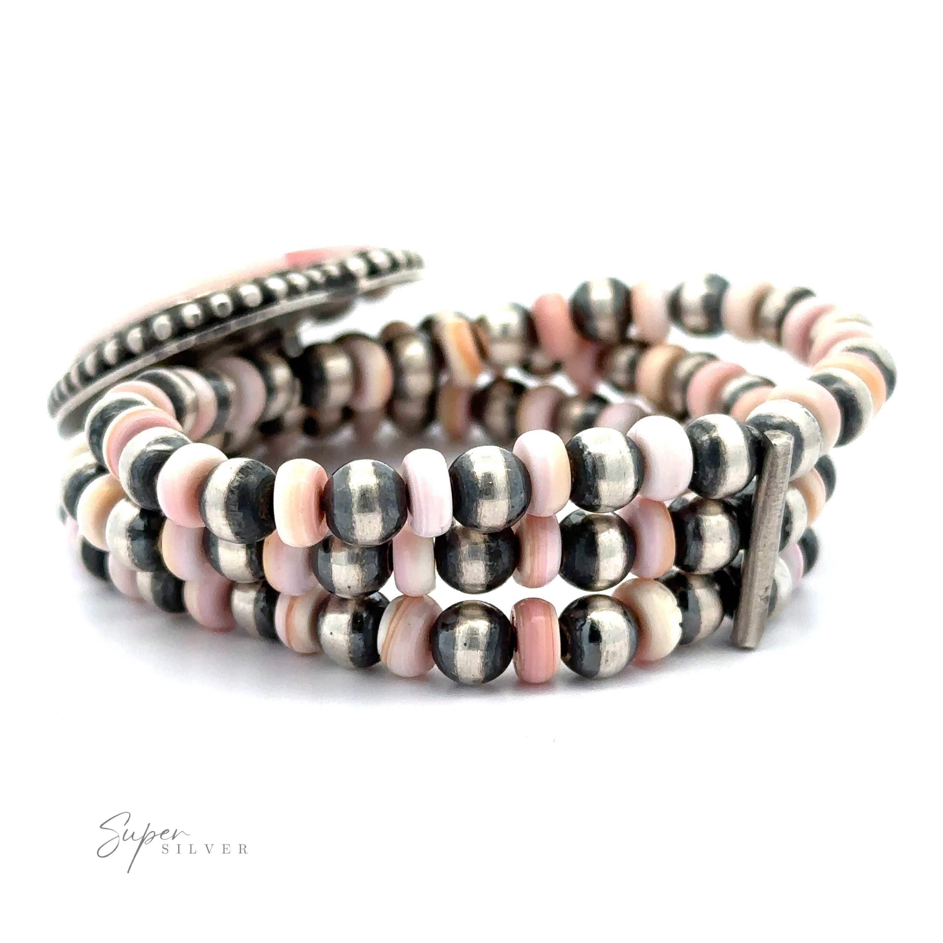 A Native American Beaded Conch Heart Bracelet displayed on a white background.