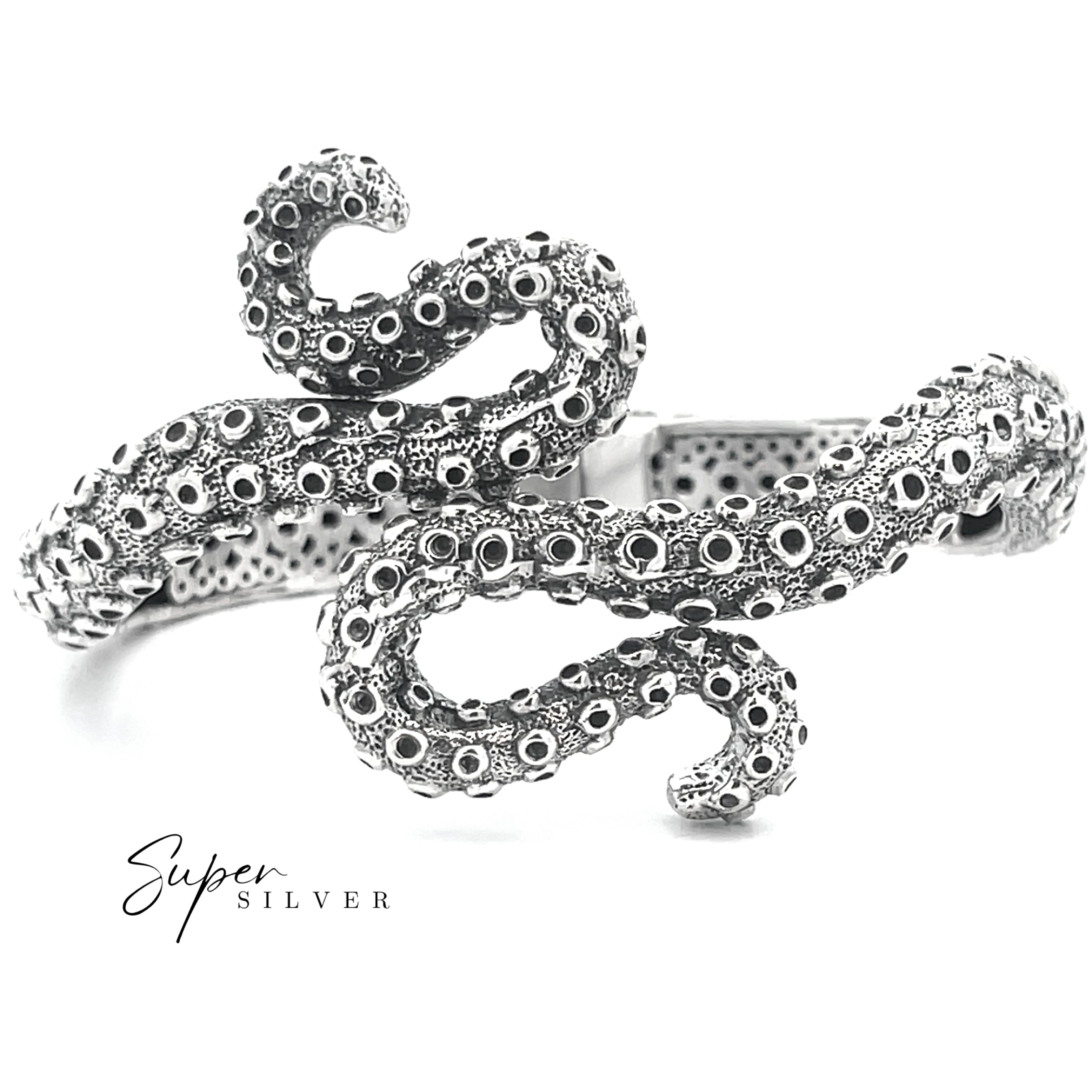 The Tentacle Hinge Cuff is a sterling silver bracelet with intricate suction cup details and a textured finish, capturing the look of an octopus tentacle. "Super Silver" appears in the lower left corner, emphasizing this artisan jewelry piece.
