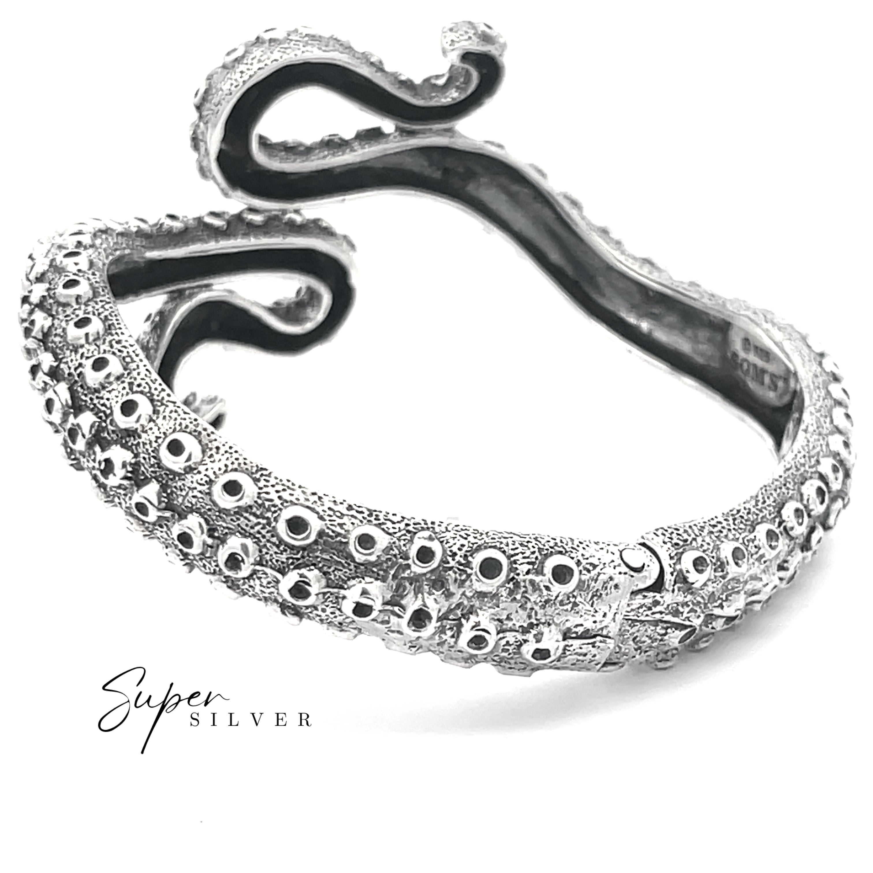 The Tentacle Hinge Cuff is a sterling silver bracelet designed to look like an octopus tentacle, with textured and raised suction cup details, shown on a white background—a striking piece of artisan jewelry.