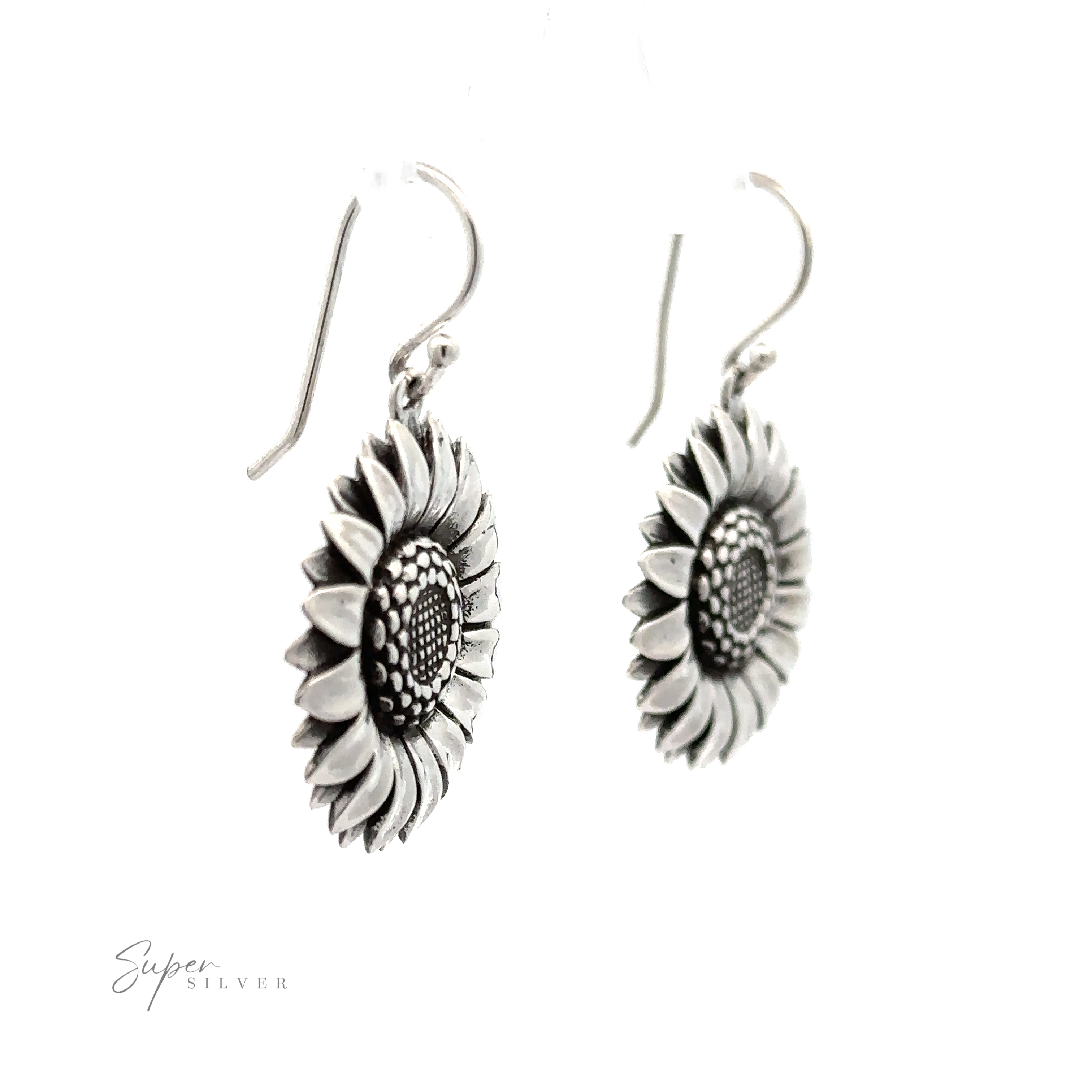 A pair of Silver Sunflower Earrings with detailed petals and textured centers, hanging from curved hooks, against a white background.