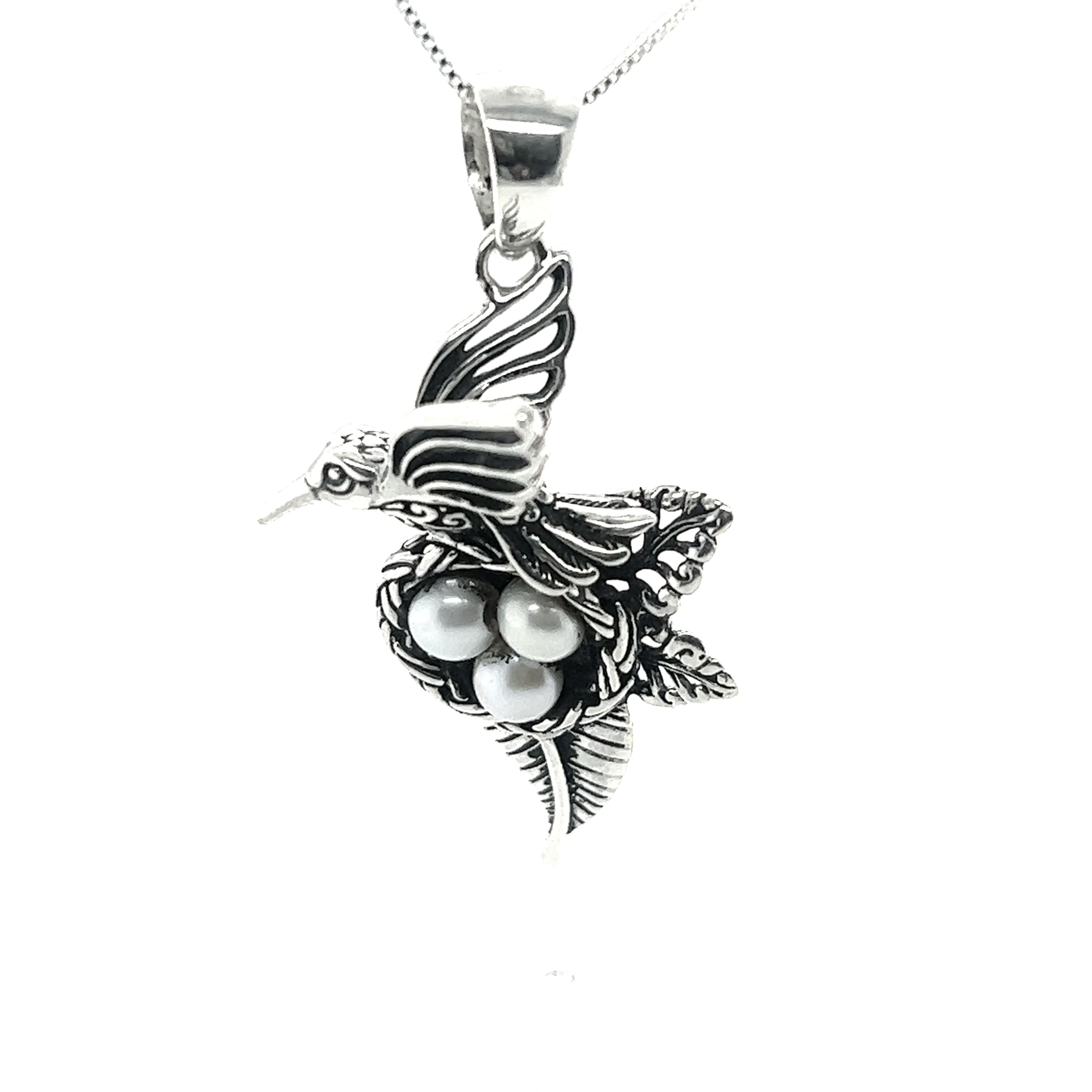 A Super Silver Hummingbird Pendant with Nest of Pearls, showcasing exquisite craftsmanship in jewelry design.