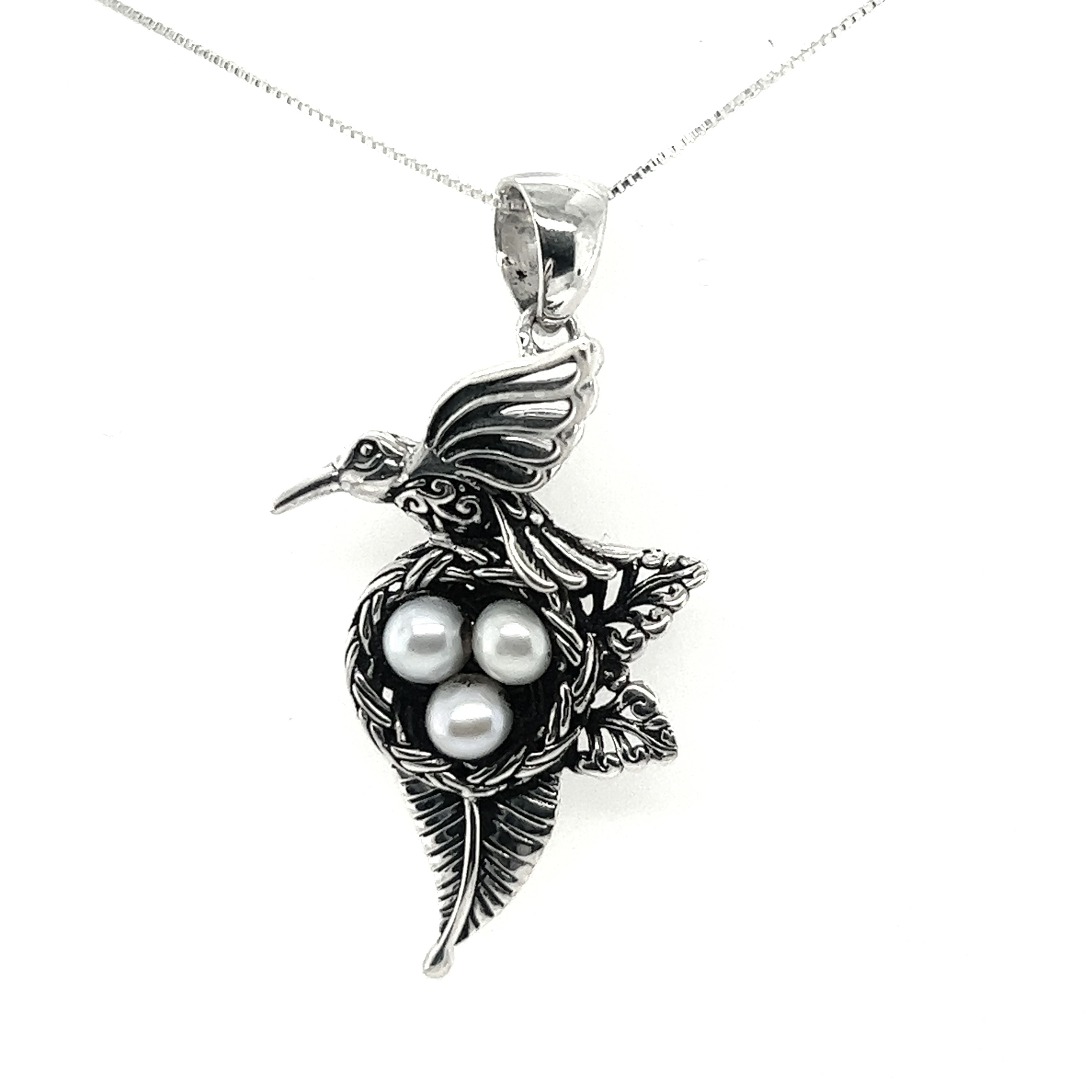 A Super Silver Hummingbird Pendant with Nest of Pearls on a silver chain.