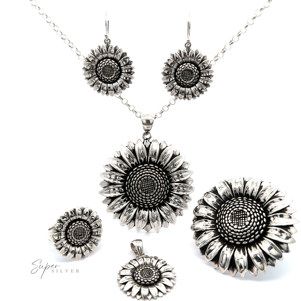 
                  
                    A collection of artisan Silver Sunflower Earrings, including a necklace, earrings, and ring, displayed on a white background.
                  
                