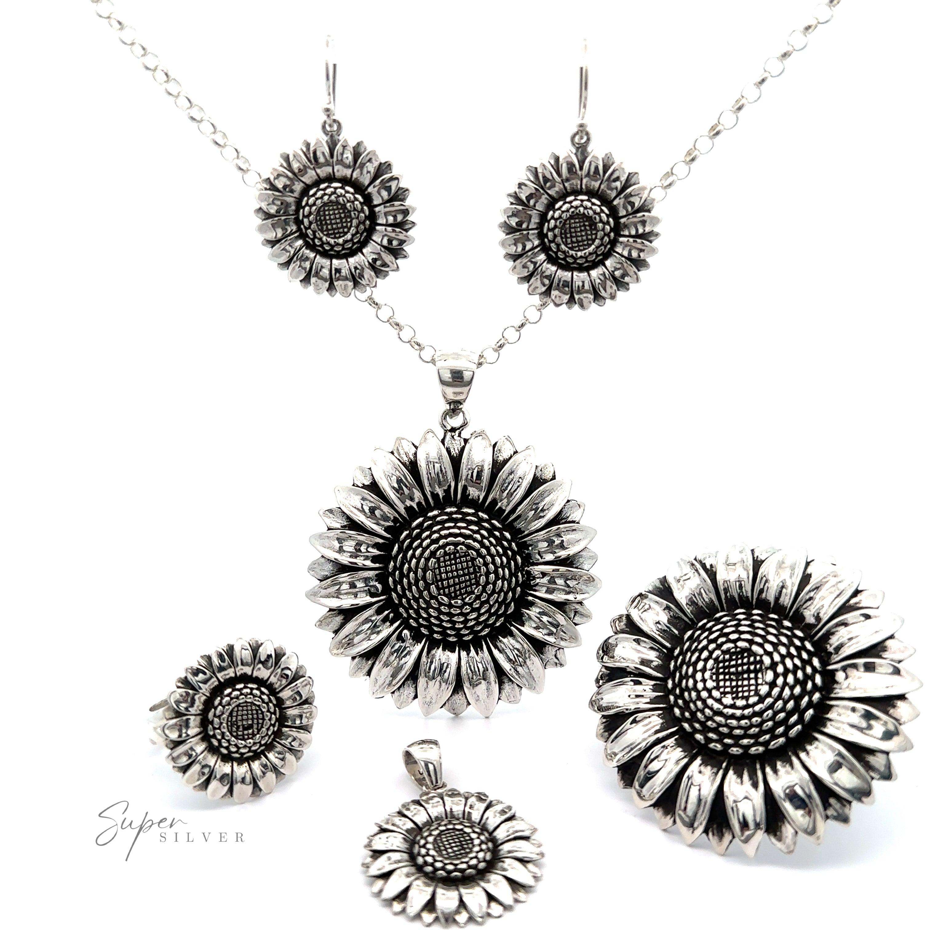 A collection of artisan Silver Sunflower Earrings, including a necklace, earrings, and ring, displayed on a white background.