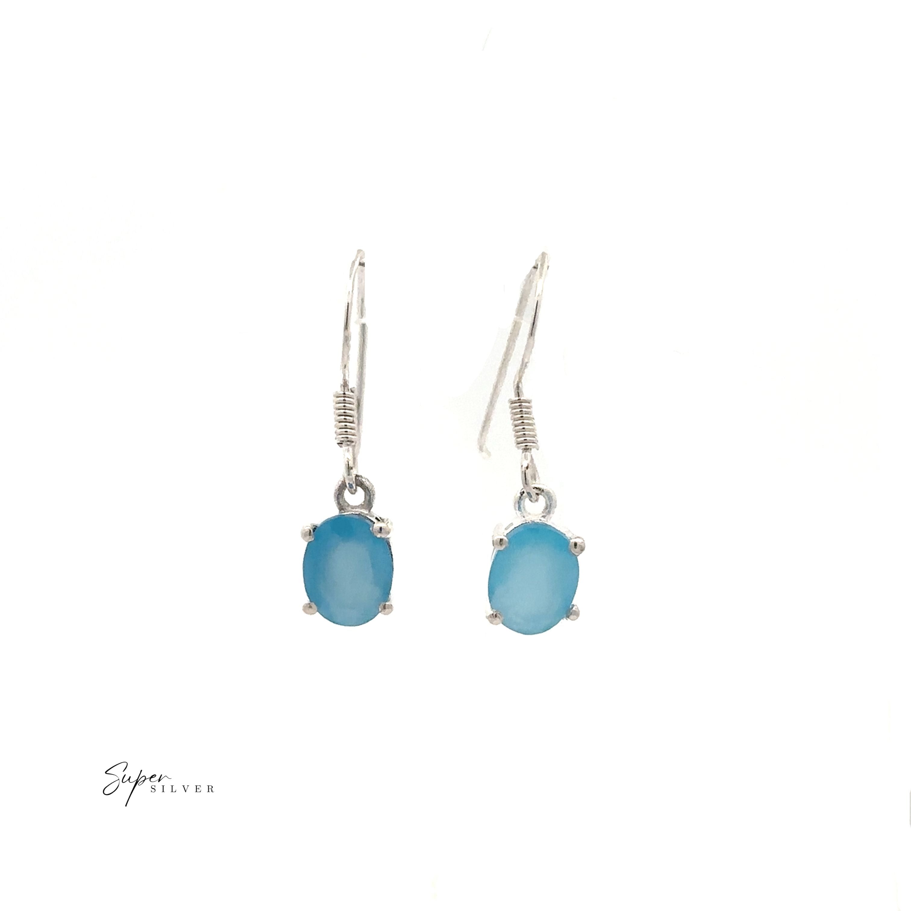Brilliant Oval Gemstone Earrings: a pair of sterling silver earrings with oval blue stones in a classic drop design, shown on a white background.