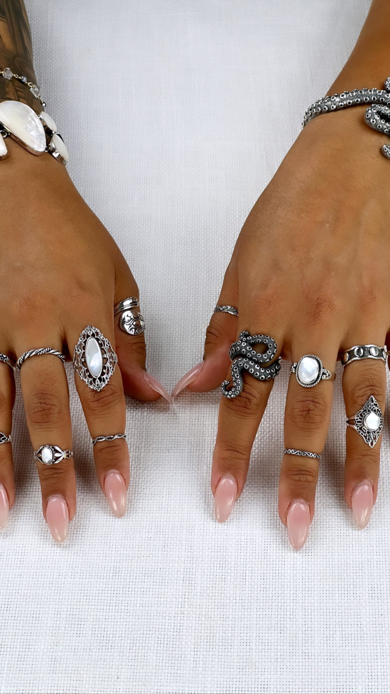 A woman's hands adorned with oceanic-inspired rings like the Statement Octopus Tentacle Ring, exuding an enigmatic allure reminiscent of the deep sea.