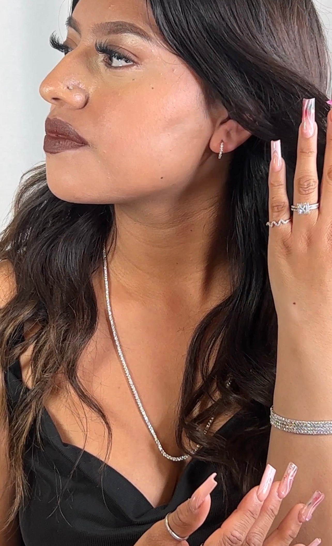 A minimalist woman wearing Super Silver sunglasses and a Super Silver sterling silver necklace.