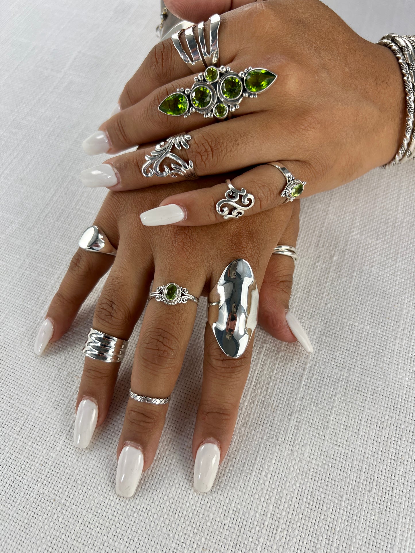 A woman's hands adorned with Super Silver's Large Shield Rings, making a bold statement and exuding boho allure.