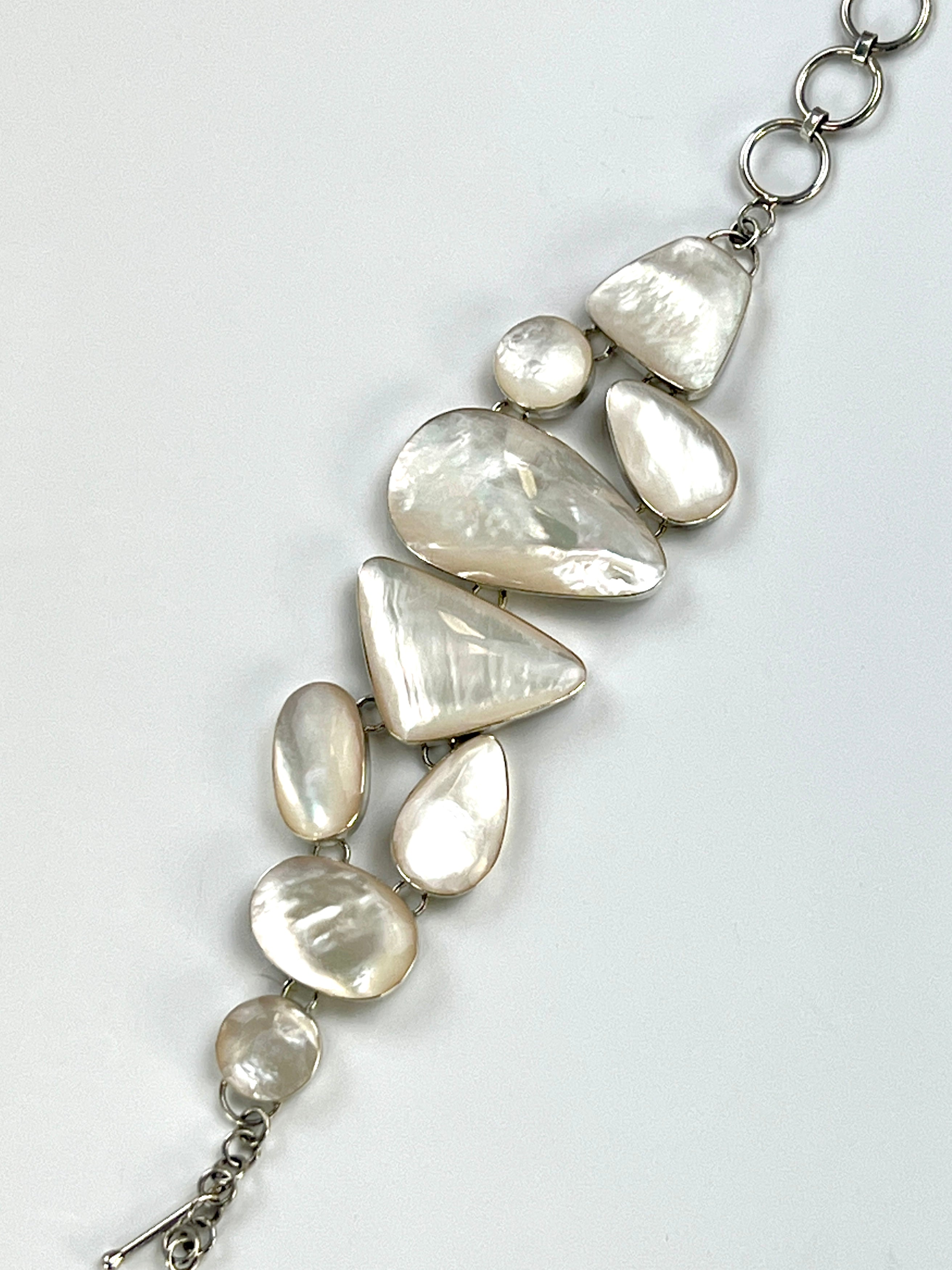 A Super Silver Statement Mother of Pearl Bracelet with a silver chain.
