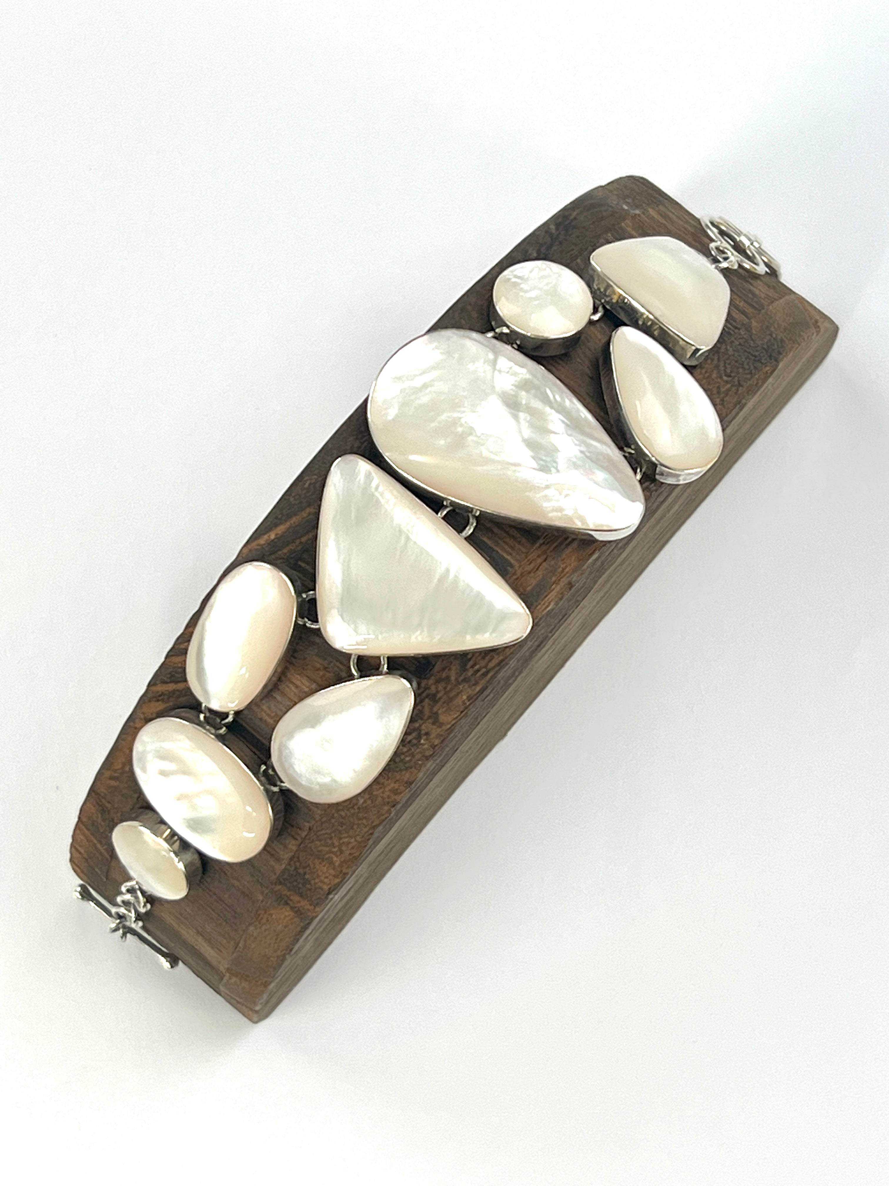 A Super Silver Statement Mother of Pearl Bracelet adorned with luminous white mother-of-pearls, exuding timeless beauty.