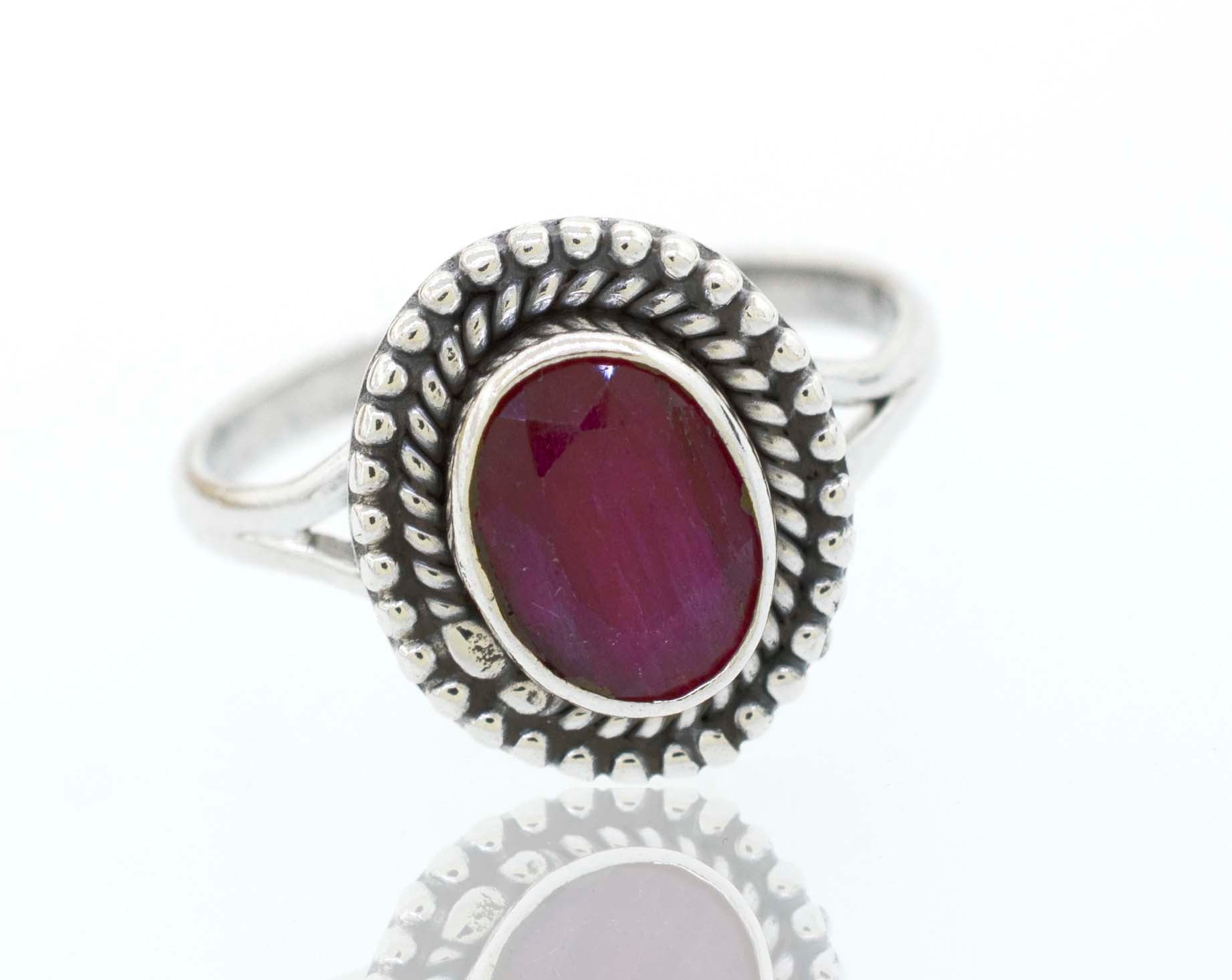 A boho silver Gemstone Oval Shield Ring with a cabochon ruby stone.