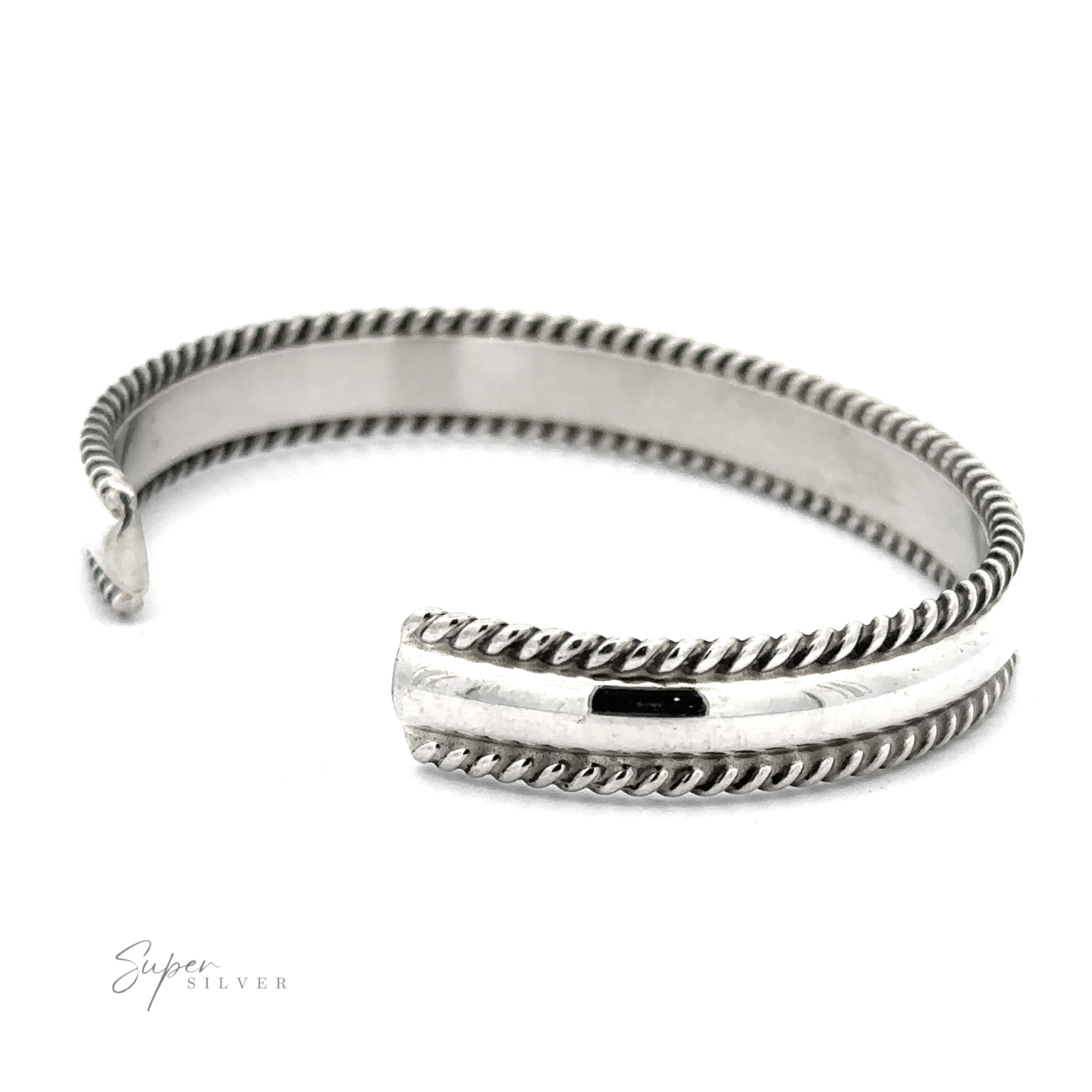 A Native American Handmade Silver Rope Cuff with braided rope-like edges and an open-ended design, labeled "Super Silver" in the bottom left corner. This statement piece captures a touch of Native American artistry, making it truly unique.