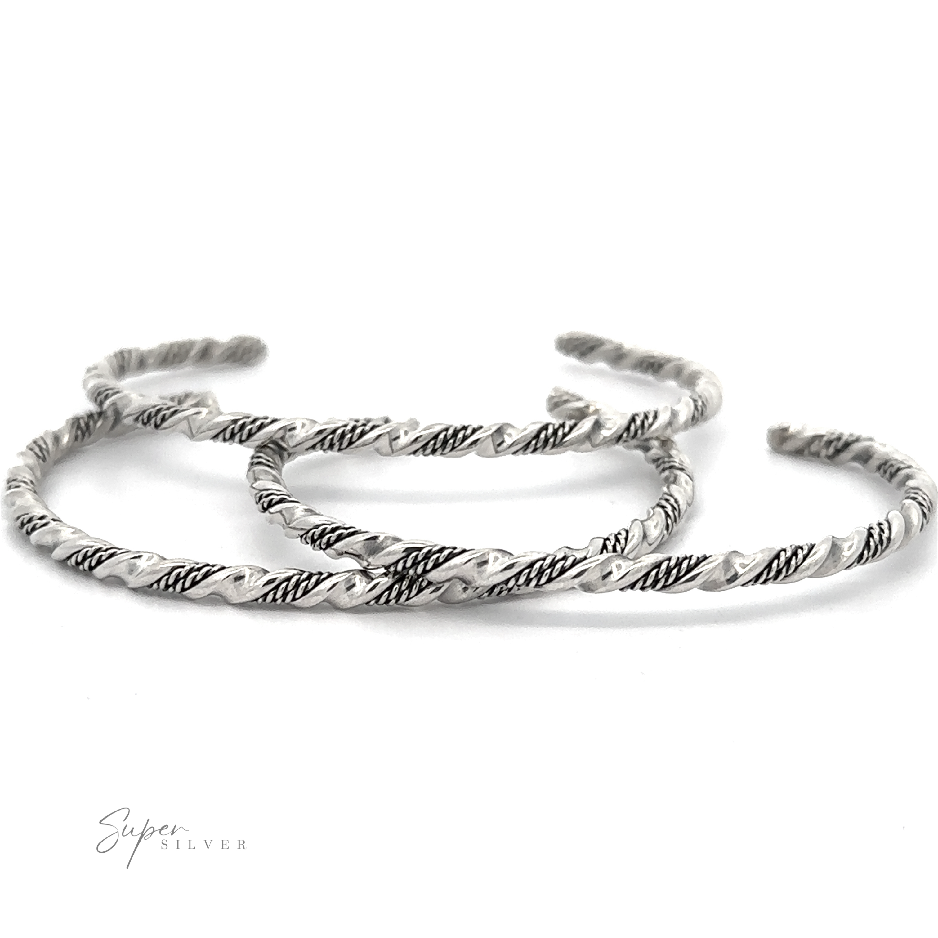Three twisted, handmade Native American Handmade Silver Rope Twist Cuff bangles with intricate patterns are arranged on a white background. The brand "Super Silver" is labeled in the bottom left corner, showcasing their Native American-inspired design.