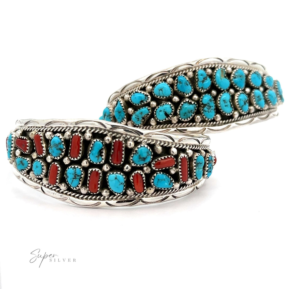 A Native American Cluster Turquoise Cuff Bracelet set with rows of turquoise and red coral in intricate Southwest charm designs.