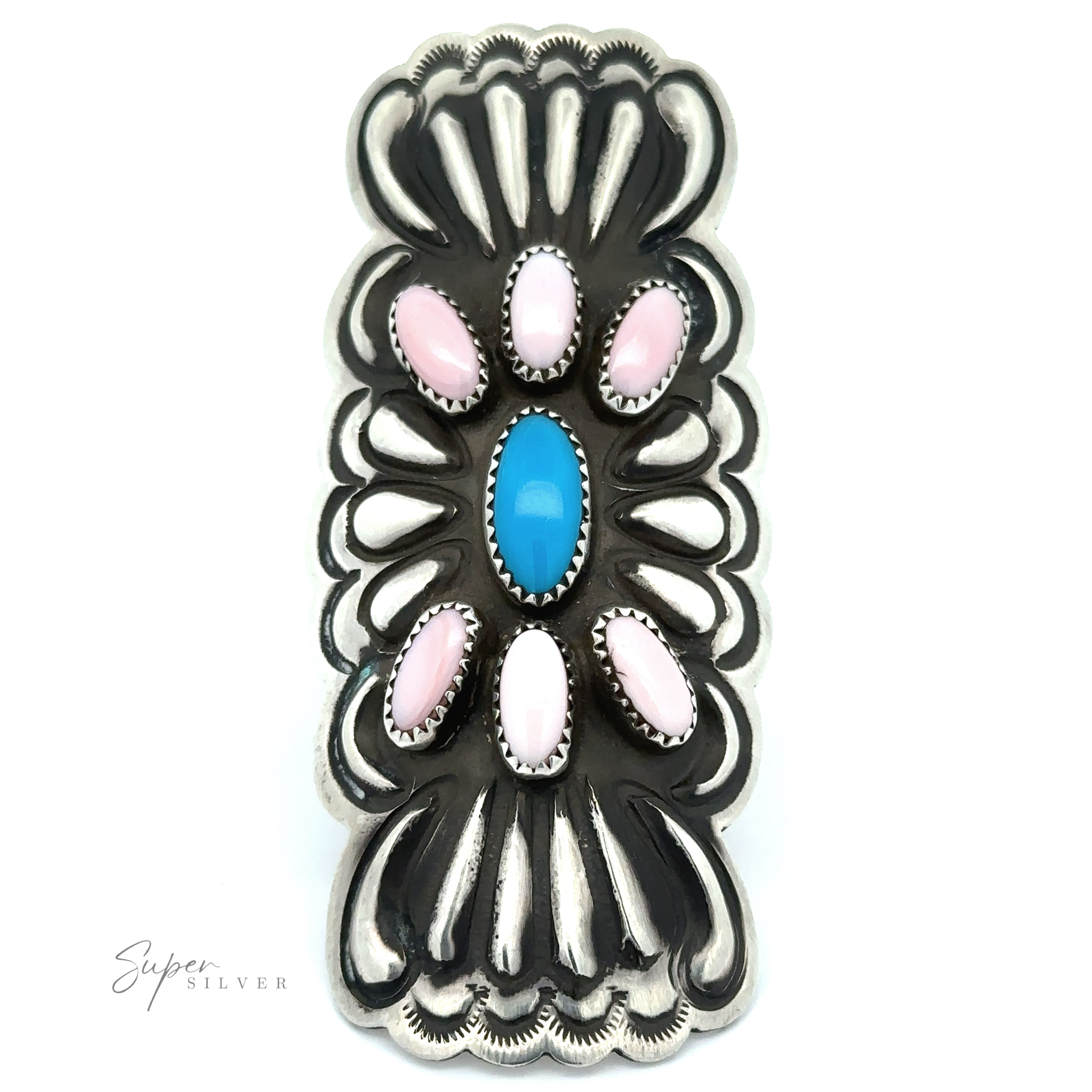 The Blush and Thunder Ring is a sterling silver piece inspired by classic Native American jewelry, featuring one oval blue stone and six symmetrically arranged oval pink stones with intricate designs.