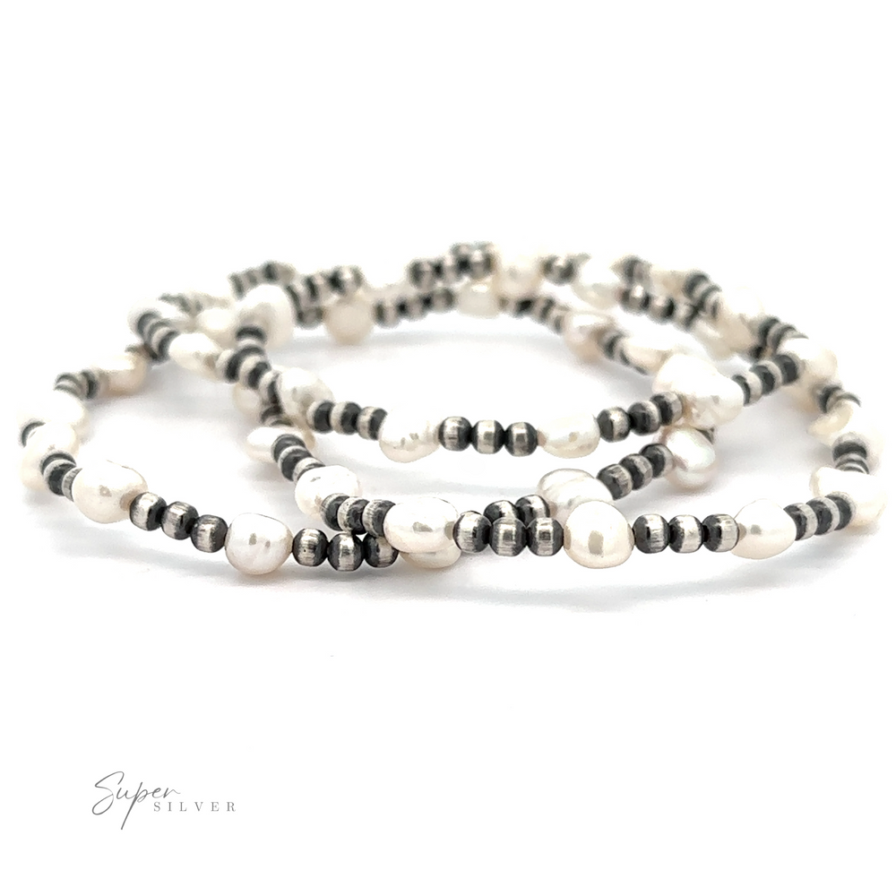 Three Native American Beaded Pearl Bracelets and hematite bead bracelets on a white surface, displaying alternating patterns of light and dark beads.