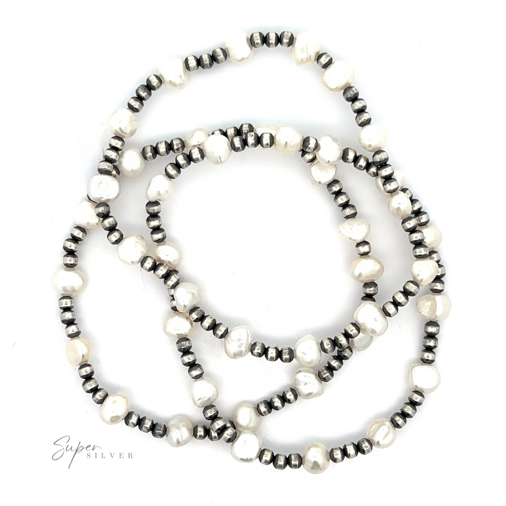 
                  
                    Three strands of a Native American beaded pearl bracelet with alternating silver and white pearls, arranged in a circular layout on a white background.
                  
                