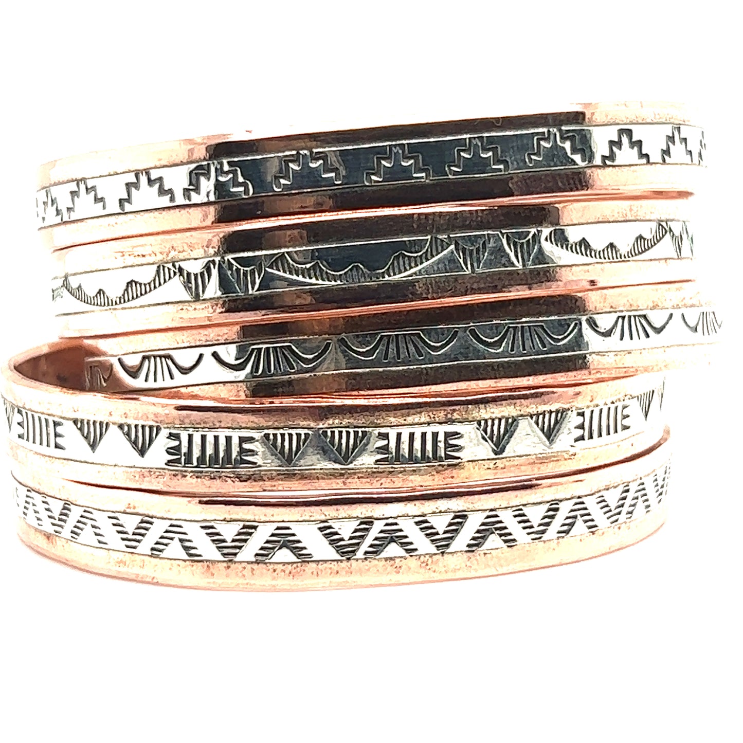 
                  
                    A handcrafted stack of Super Silver Native American Handmade Copper And Silver Bracelets with intricate designs.
                  
                
