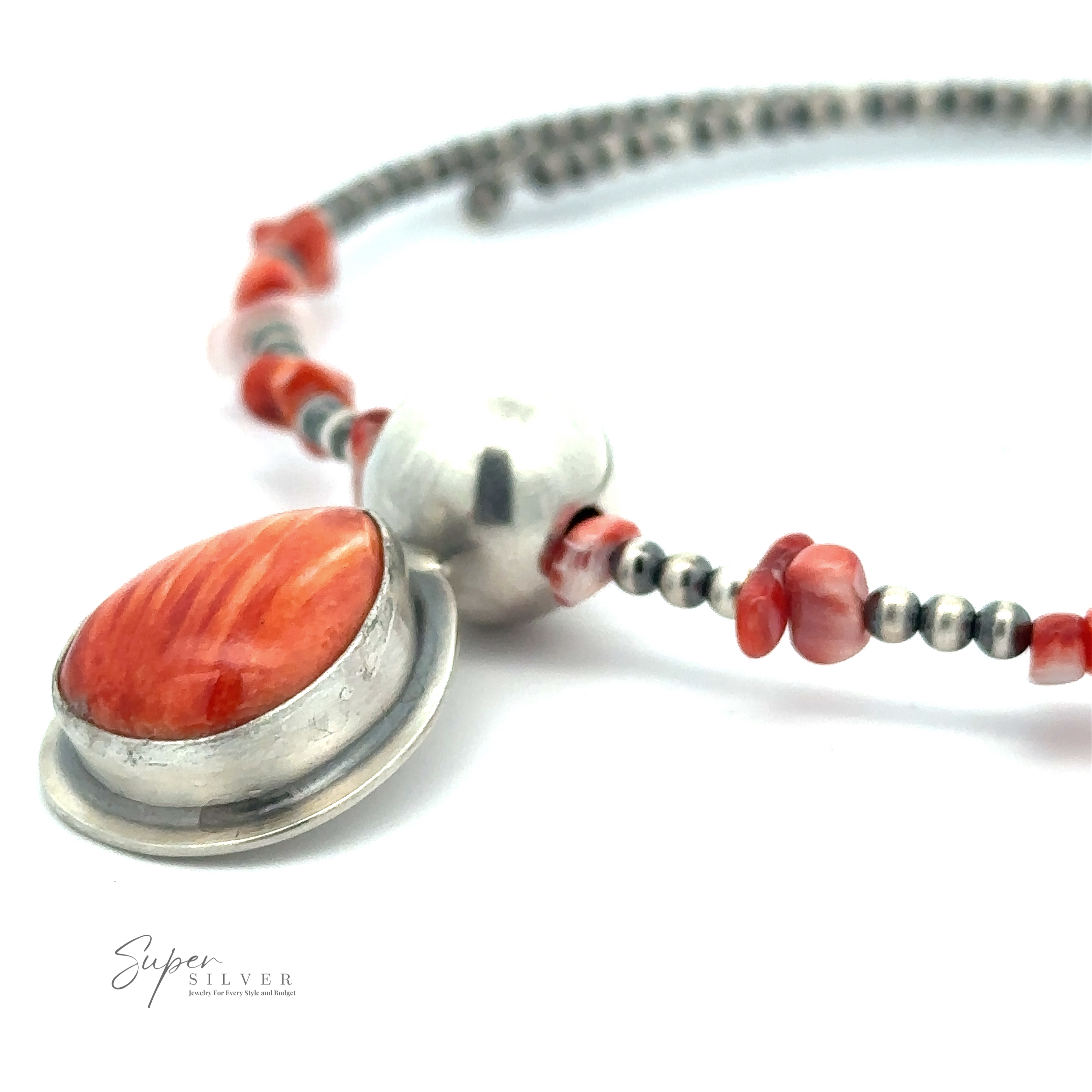A close-up of a beaded necklace featuring a large oval red-orange stone set in a silver clasp, reminiscent of Navajo pearls. Small round and irregular red beads surround a larger silver bead. Text reads "Wrap Around Spiny Oyster Shell Choker Necklace".