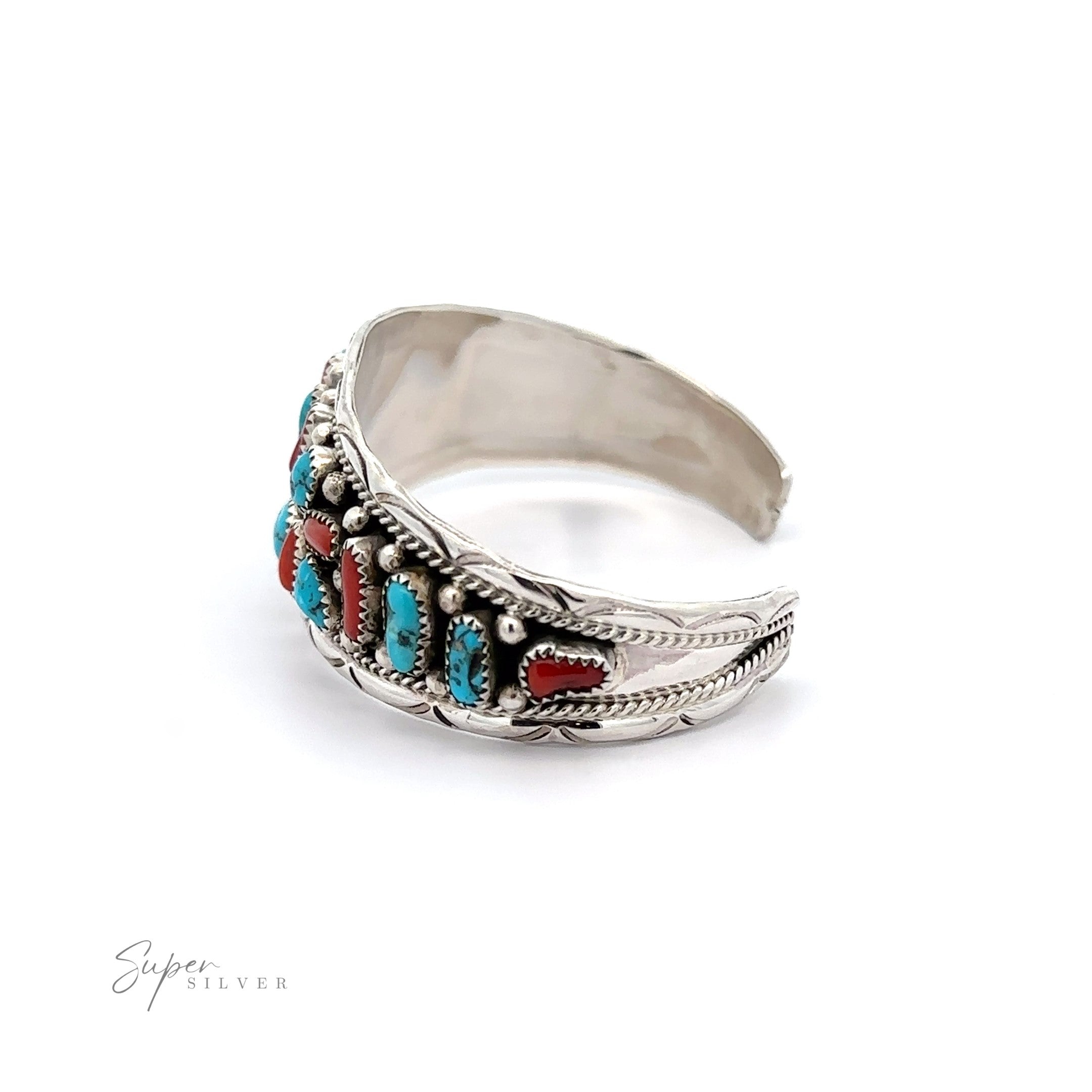 Native American Cluster Turquoise Cuff Bracelet with intricate designs and Southwest charm, featuring embedded turquoise and coral stones, isolated on a white background.