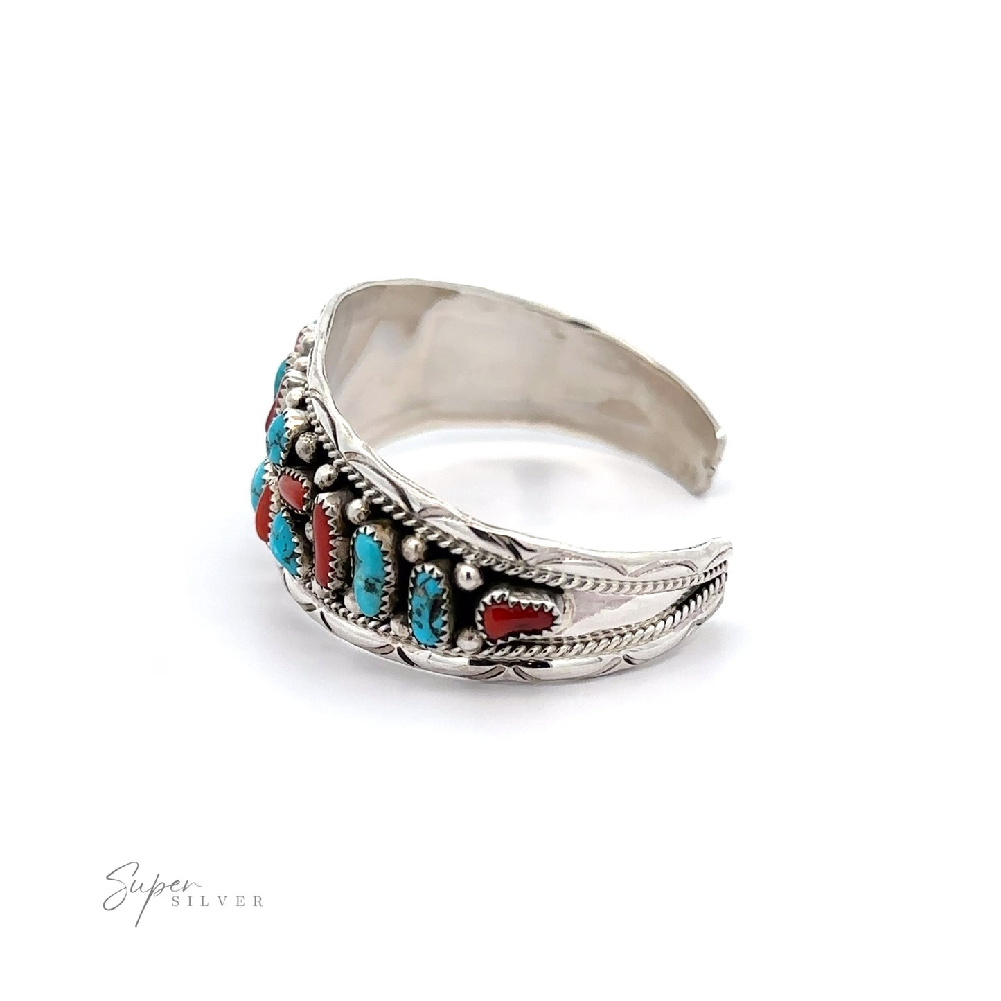 
                  
                    Native American Cluster Turquoise Cuff Bracelet with intricate designs and Southwest charm, featuring embedded turquoise and coral stones, isolated on a white background.
                  
                