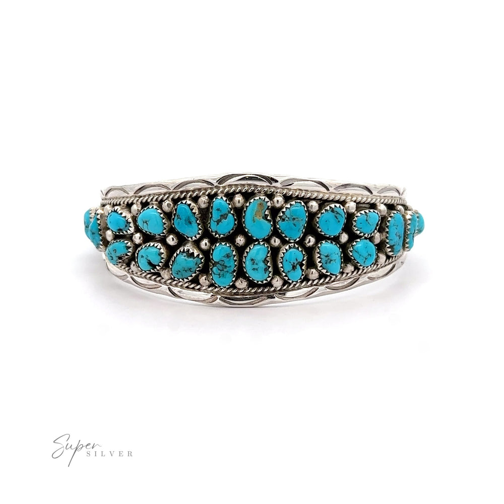 Native American Cluster Turquoise Cuff Bracelet featuring multiple turquoise stones set in detailed metalwork, displaying Southwest charm, against a white background.
