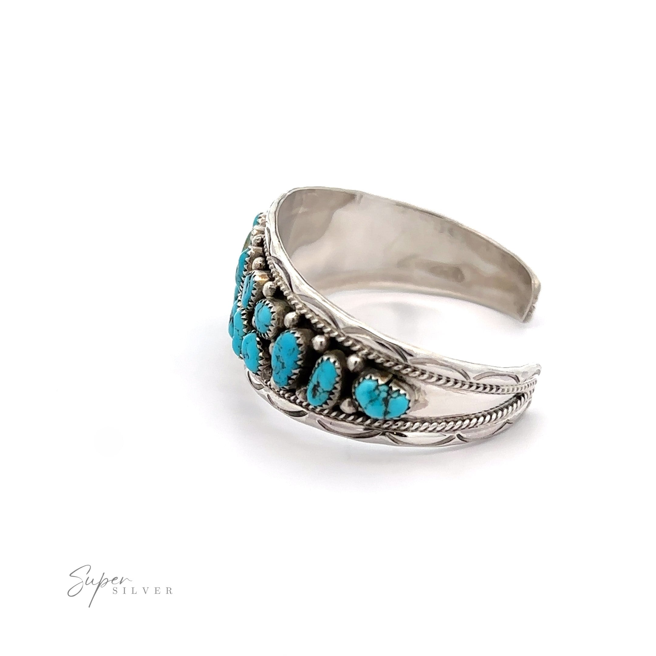 A Native American Cluster Turquoise Cuff Bracelet adorned with detailed metalwork on a white background, reflecting the Native American jewelry style.