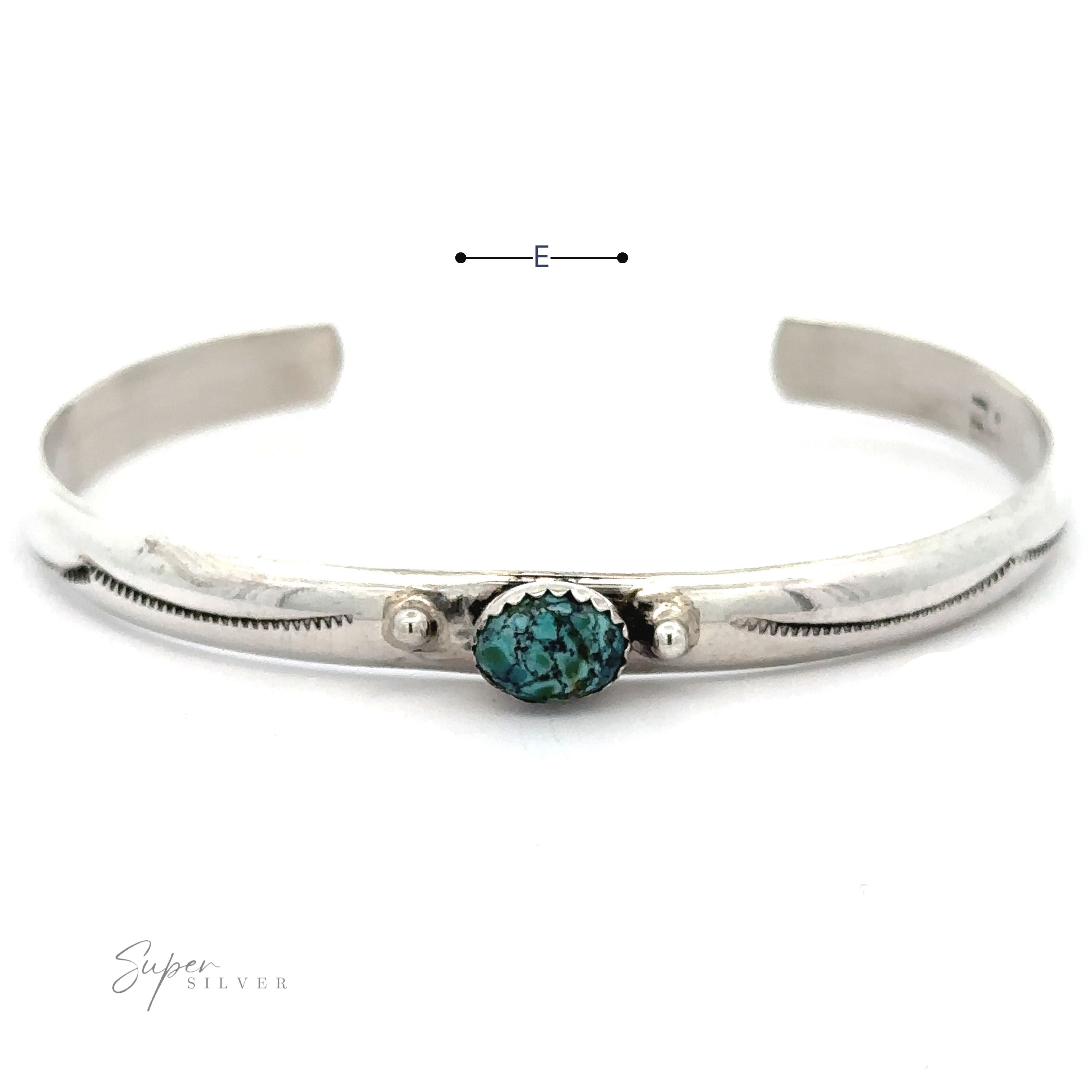 A Striking Native American Turquoise Cuff with Diamond Etching featuring a central Kingman Turquoise stone. Handcrafted Navajo cuff design with the brand logo "Super Silver" visible in the bottom left corner.