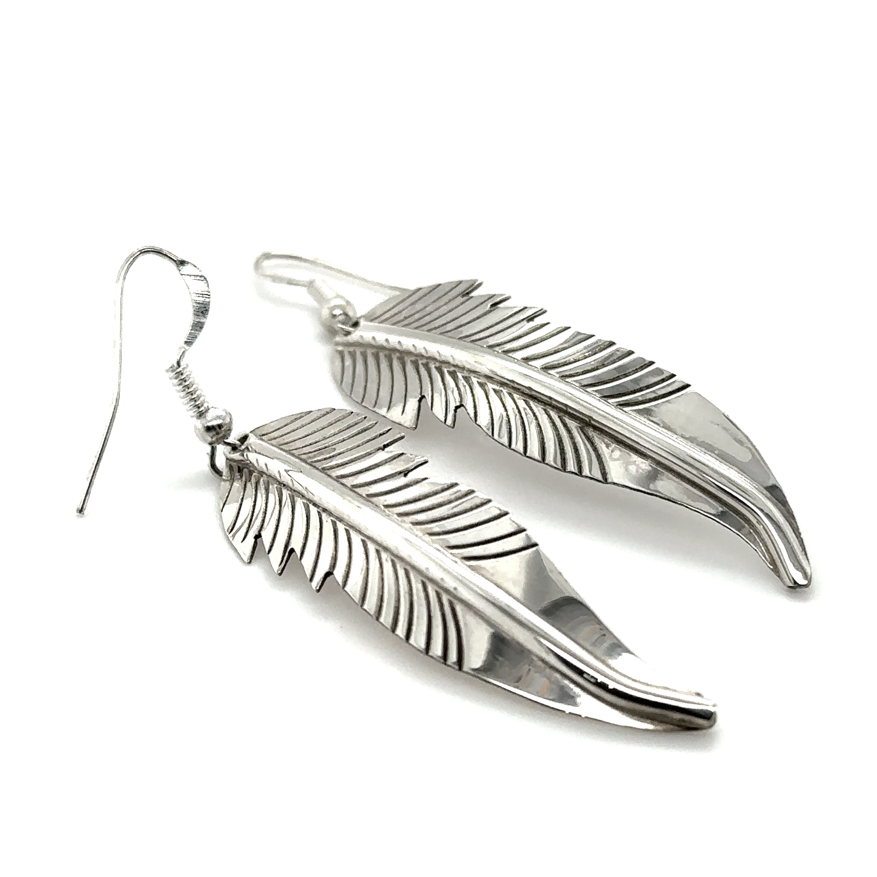A pair of striking Native American feather earrings on a white background.