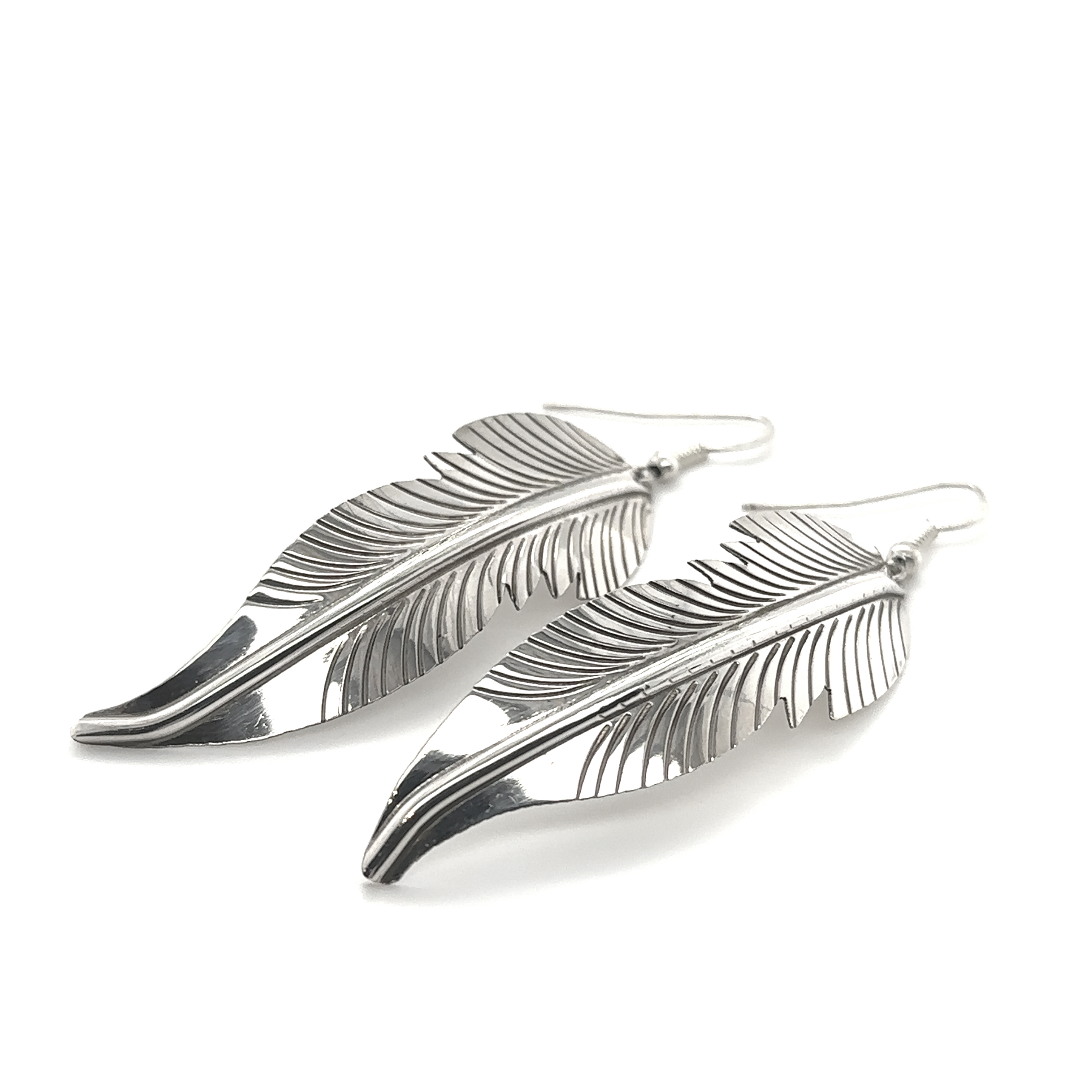 A pair of Super Silver Striking Native American Feather Earrings on a white background.