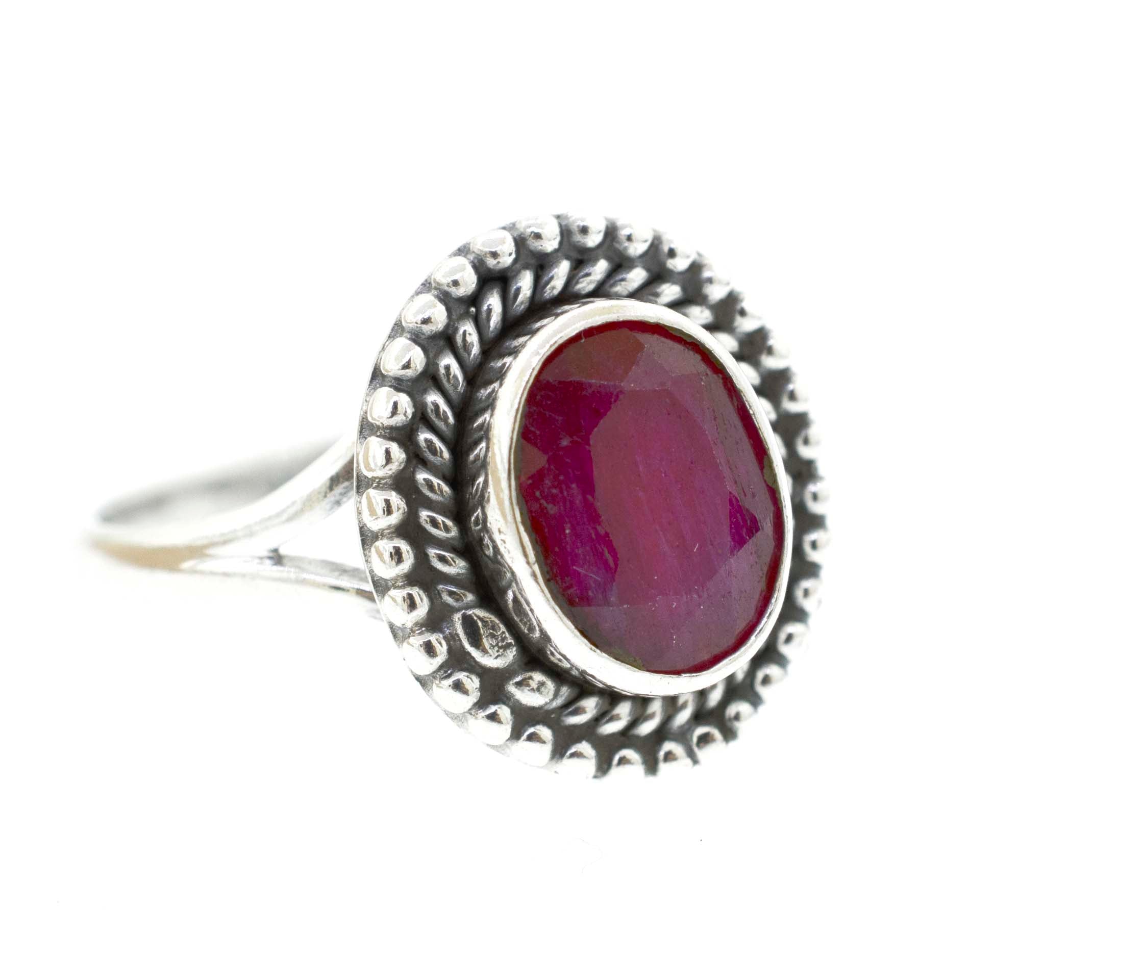 A silver Gemstone Oval Shield Ring with a ruby cabochon stone.