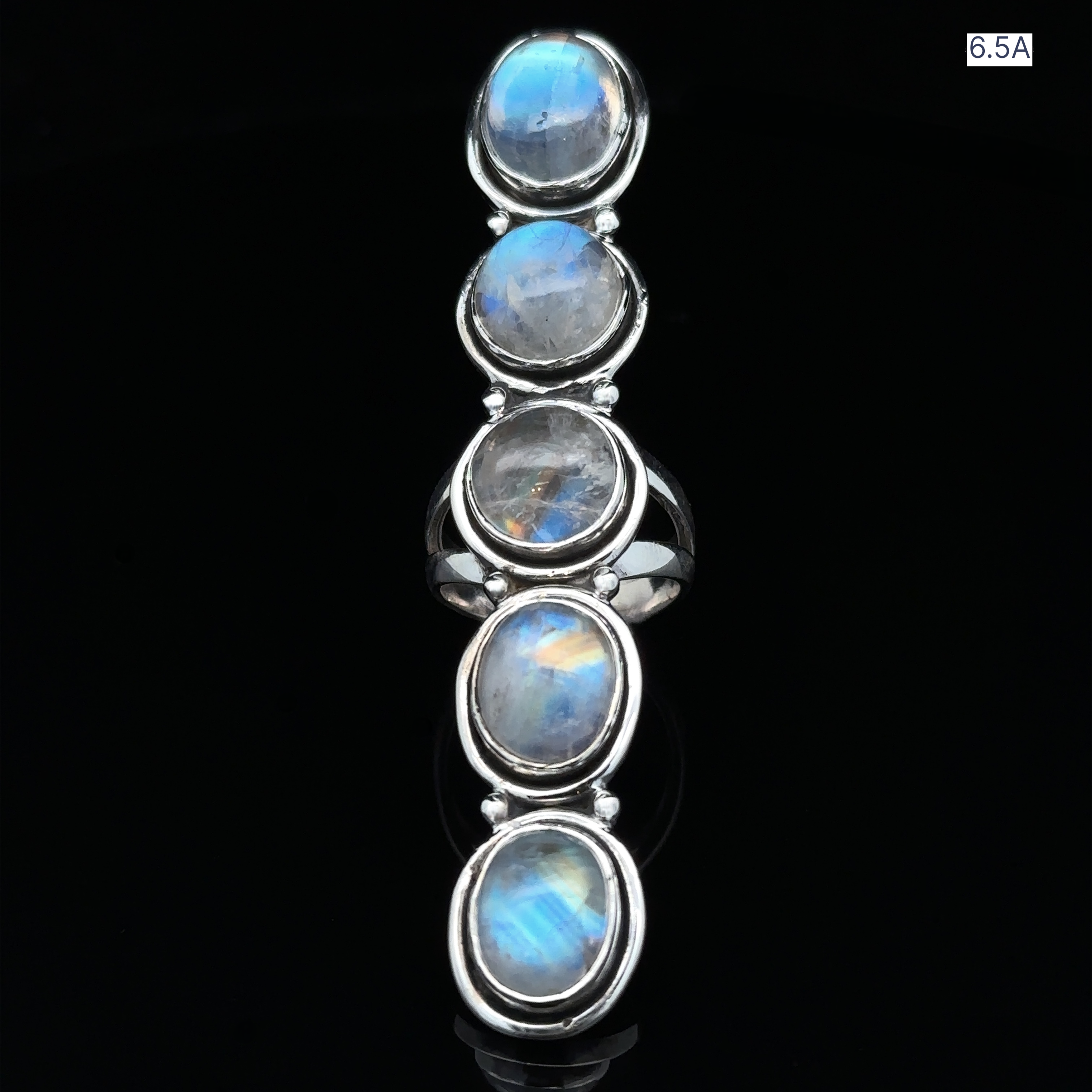 The Moonstone Ladder Ring in sterling silver showcases five vertically set oval blue moonstone cabochons on a black background, labeled size 6.5A in the corner.