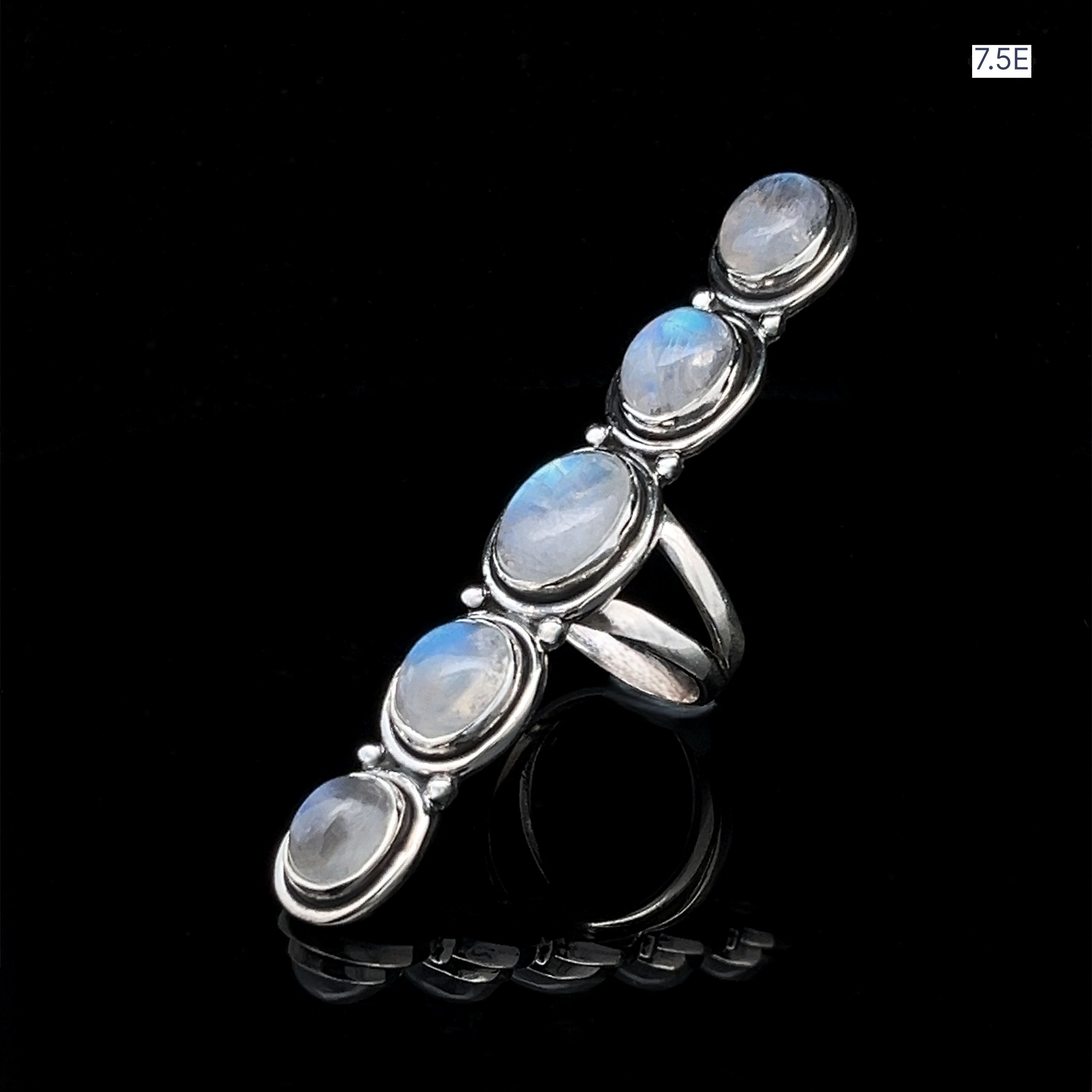 The Moonstone Ladder Ring is a sterling silver bohemian piece featuring five oval moonstone cabochons set in a vertical line, shown against a black background.