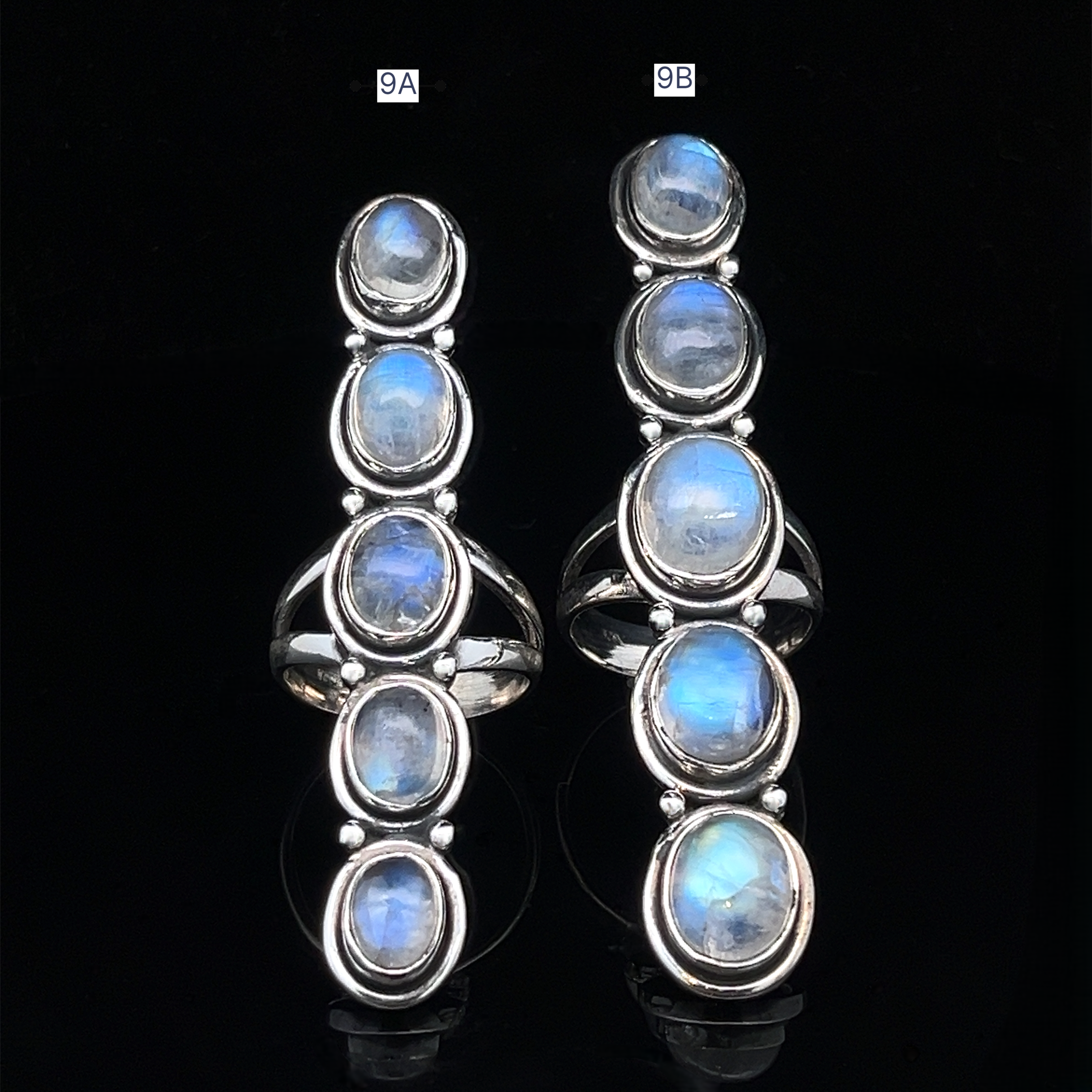 Two Moonstone Ladder Rings in sterling silver each feature five oval blue moonstone cabochons arranged vertically against a black background.