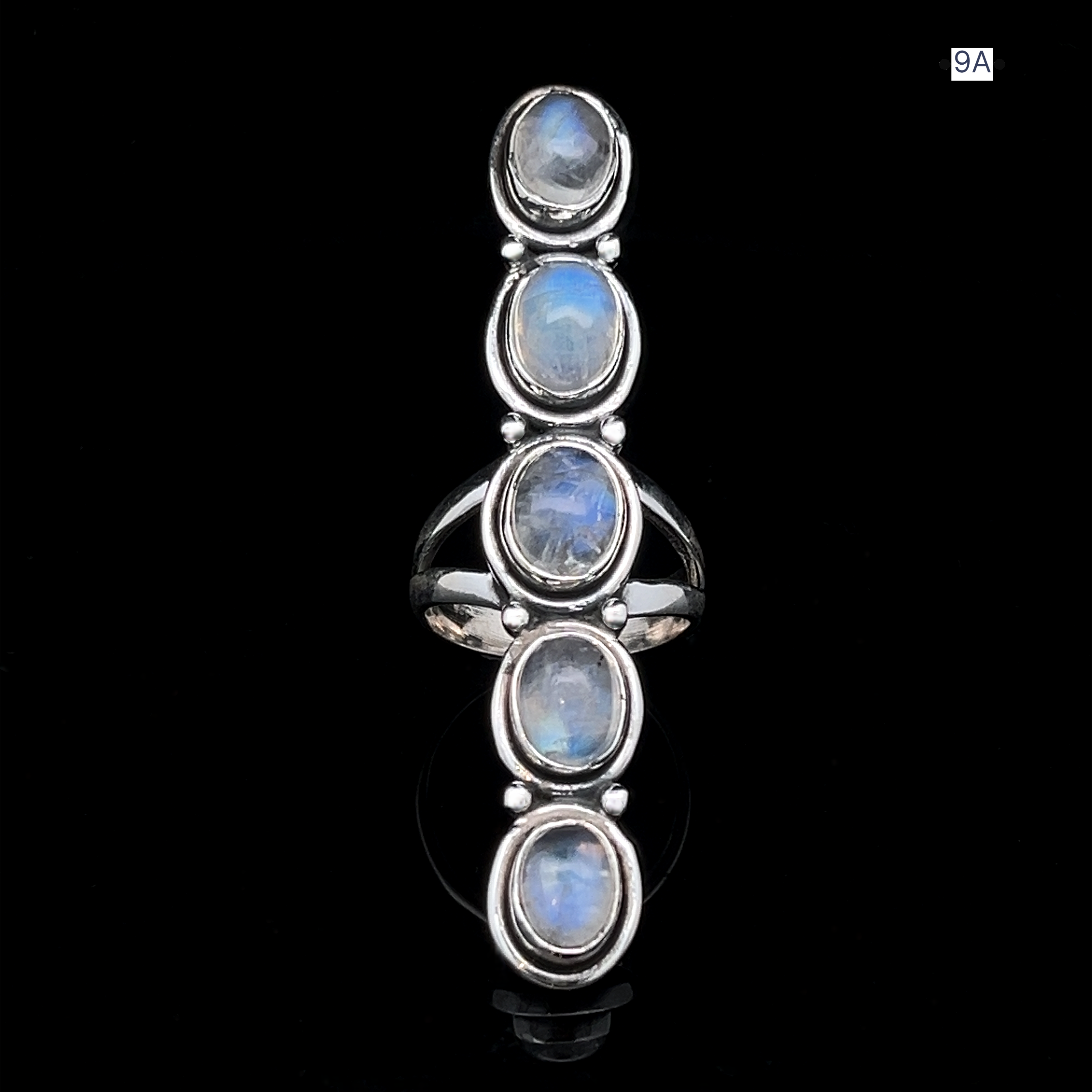 The Moonstone Ladder Ring is a sterling silver Bohemian piece with five oval moonstone cabochons set vertically against a bold black background.