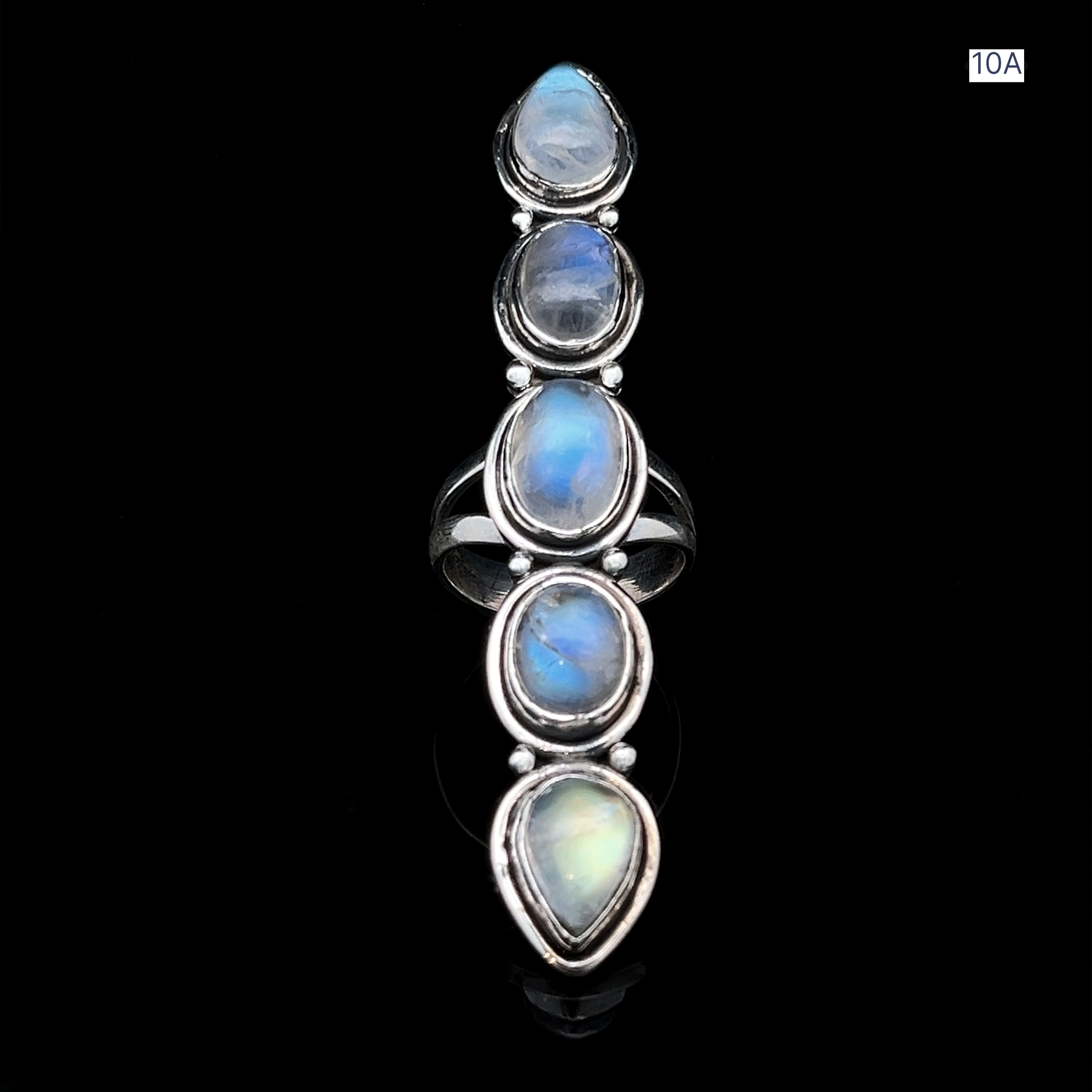 The Moonstone Ladder Ring is a sterling silver bohemian piece with five vertically aligned oval blue moonstone cabochons in classic bezel settings, shown on a black background.