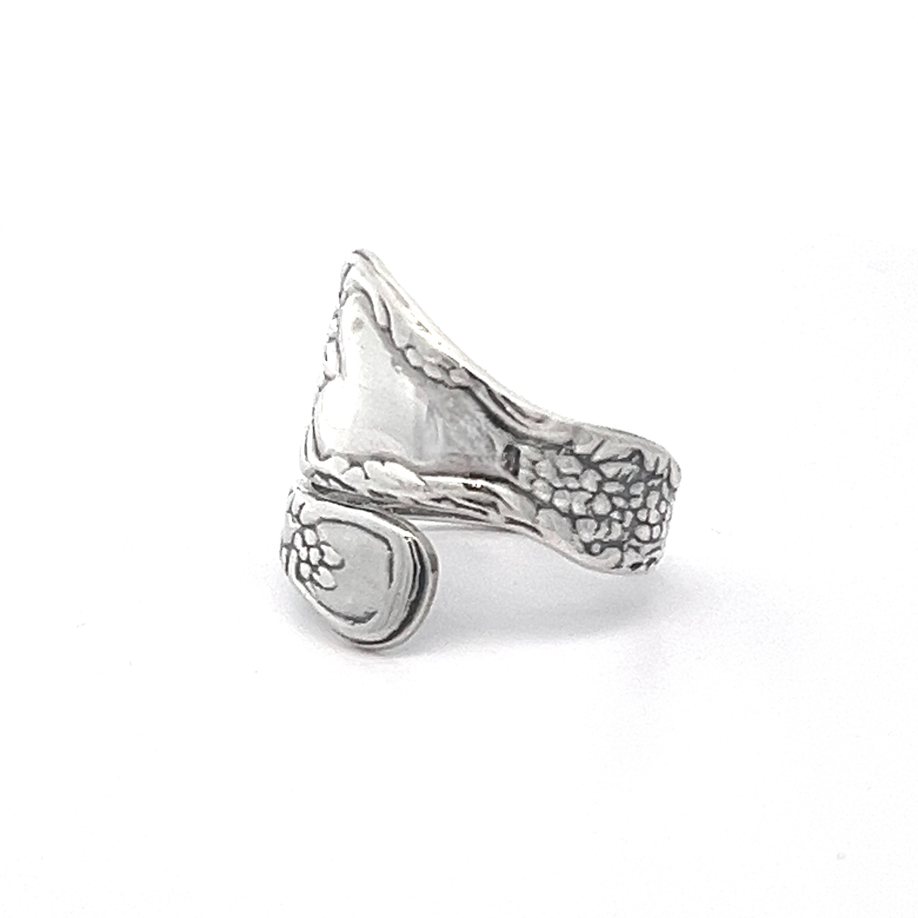 The Timeless Spoon Rings are designed to resemble a spoon, featuring an intricate floral pattern with a delicate grapevine motif.